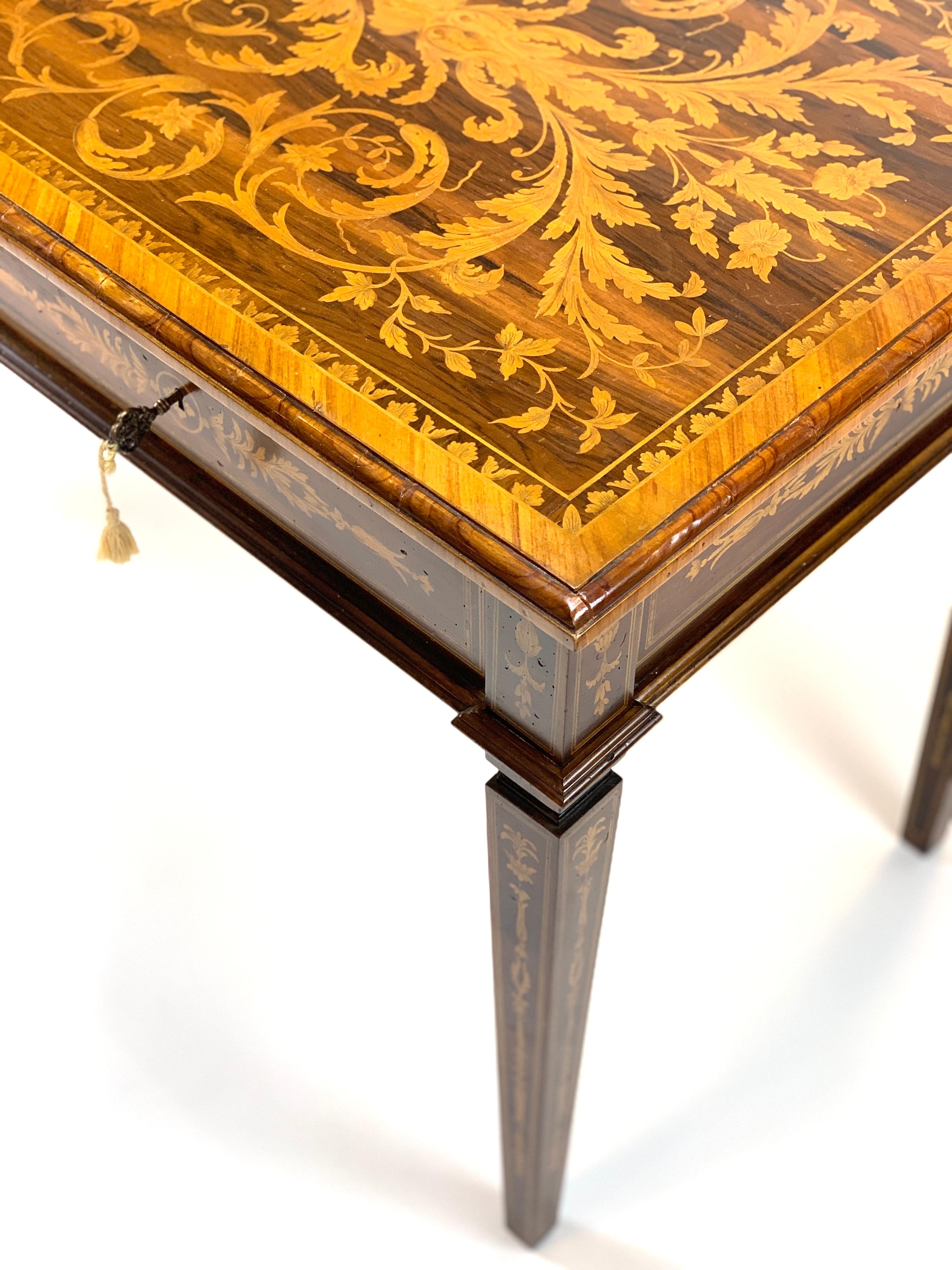 Extraordinarily detailed 19th century handcrafted writer's desk with exceptional floral marquetry inlay. Intricate tapering legs leading to the top with locking drawers and original key.