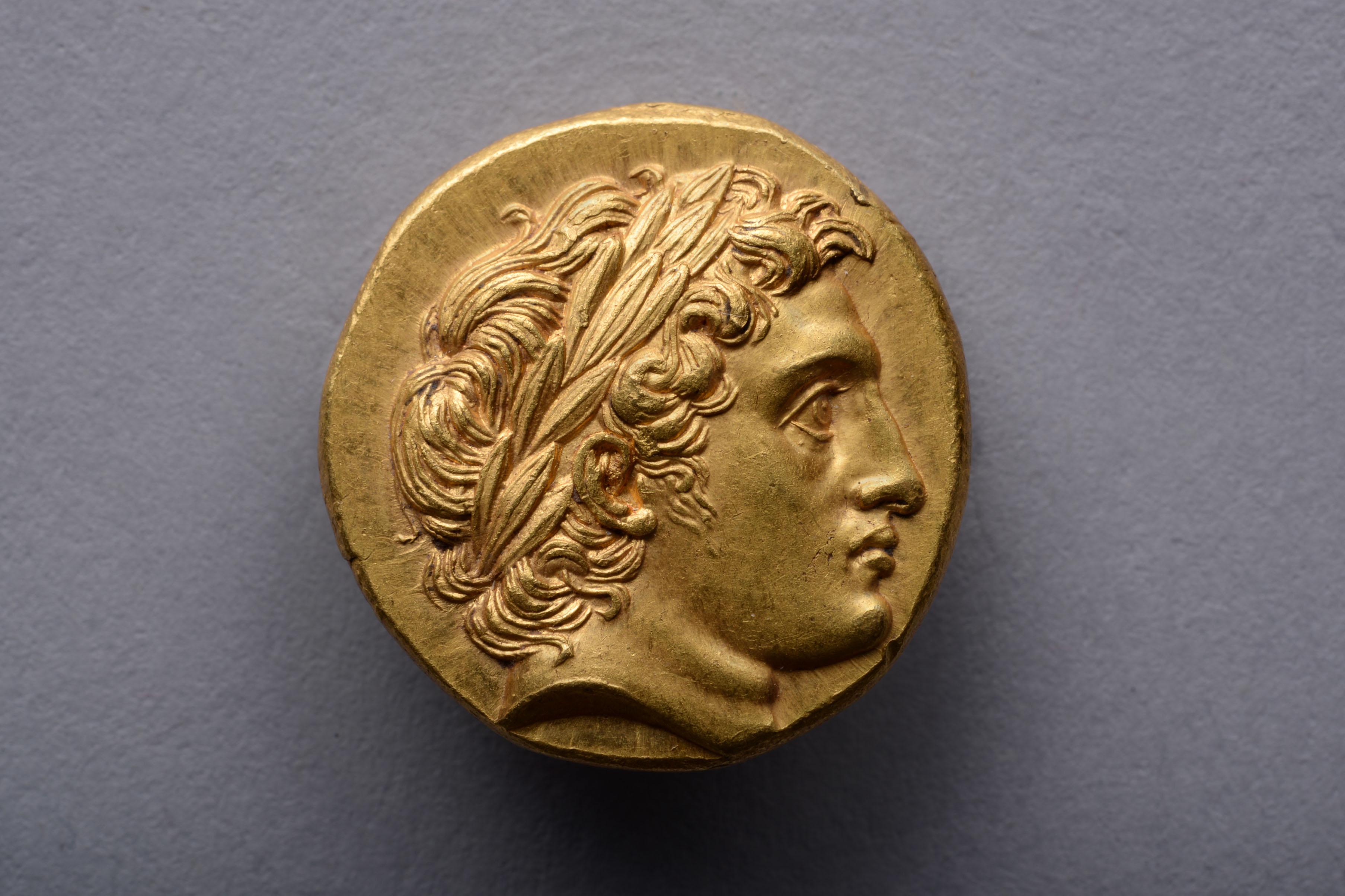 A magnificent, gem-like coin with a sublime portrait of Alexander the Great. This gold stater was issued under Alexander's brother Philip III, and was struck at the Colophon mint, circa 322-319 BC.

The obverse with one of the most beautiful