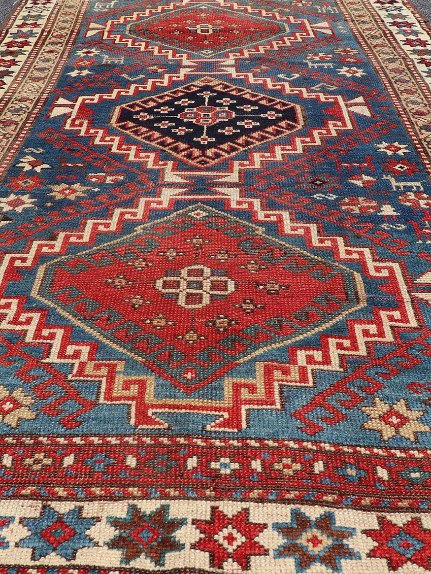 Wool Antique Caucasian Kazak Rug in Brilliant Blue with Geometric Design Medallion's For Sale