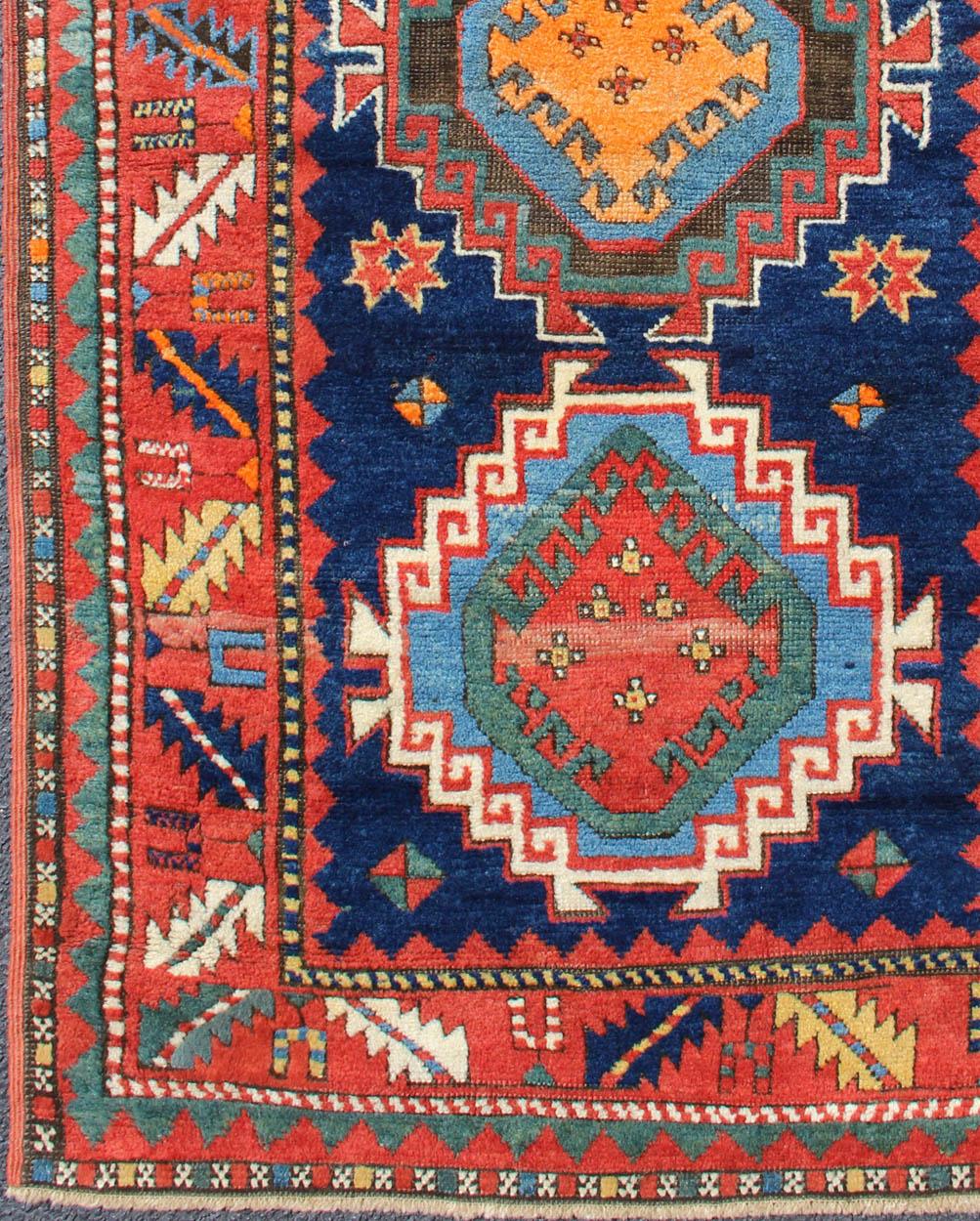 Tribal geometric medallion design Kazak rug antique from Caucasus Region in multi-colors, rug 17-0910, country of origin / type: Iran / Caucasian Kazak, circa 1880.

Brilliant Kazak rugs are among the most desirable Caucasian rugs. The vibrant reds,