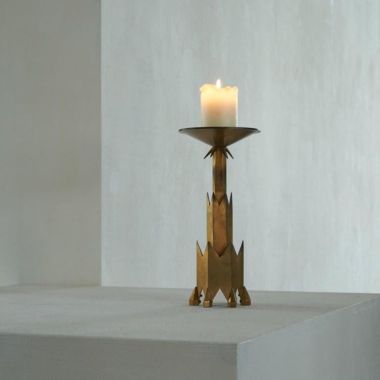 Remarkable Art Deco candle holder in patinated brass, first half of the 20th century.    A beautiful and sizeable candle holder with a remarkable Art Deco design. This candle holder is a beautiful piece of art deco design. Sharp and pointed and rich