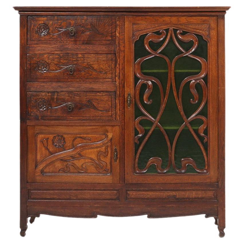 Remarkable Art Nouveau cabinet in oak with green glass door, France, 1910 For Sale