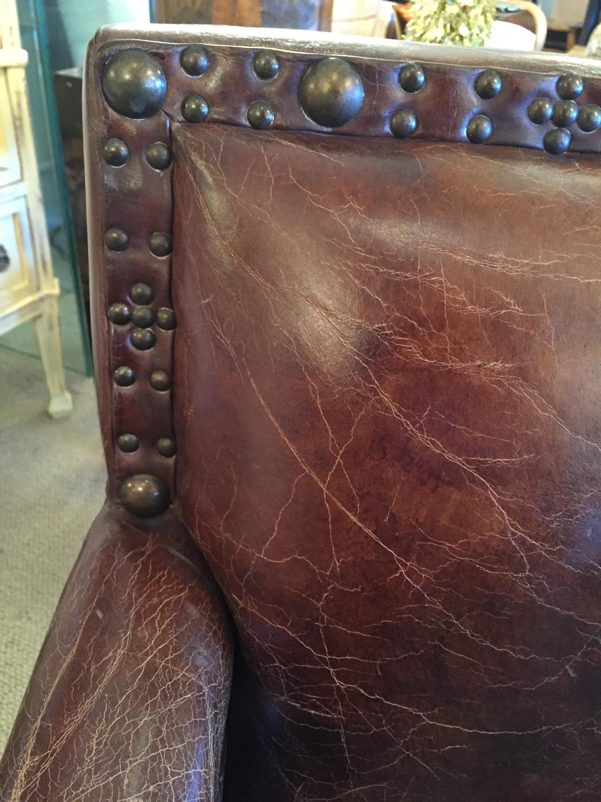 Remarkable Distressed Leather Loveseat with French Brass Nailheads In Excellent Condition In Hopewell, NJ