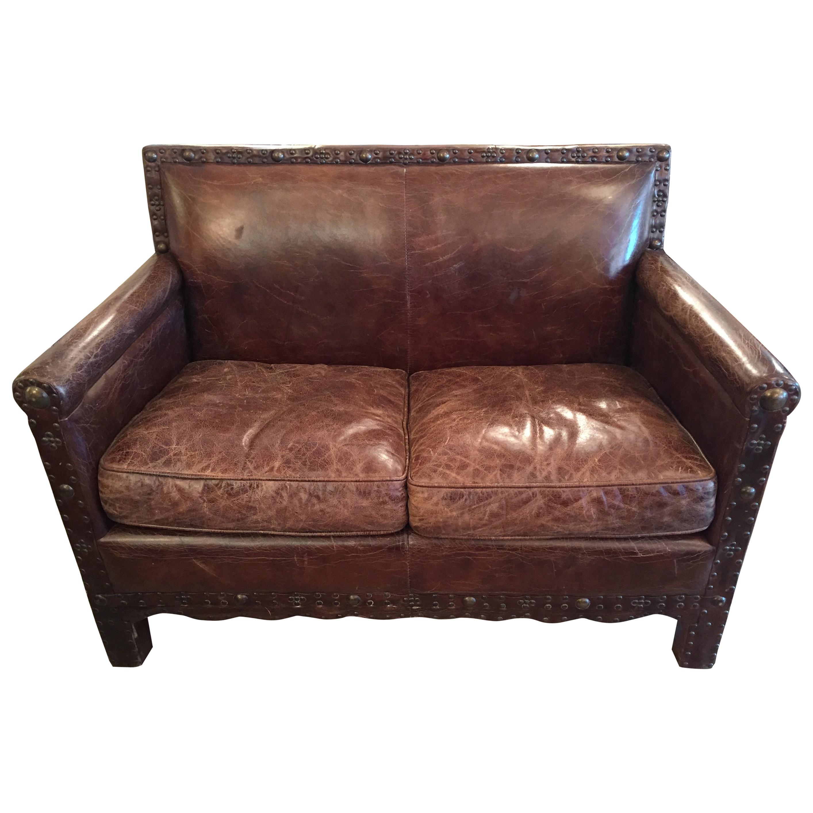 Remarkable Distressed Leather Loveseat with French Brass Nailheads