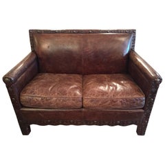 Remarkable Distressed Leather Loveseat with French Brass Nailheads