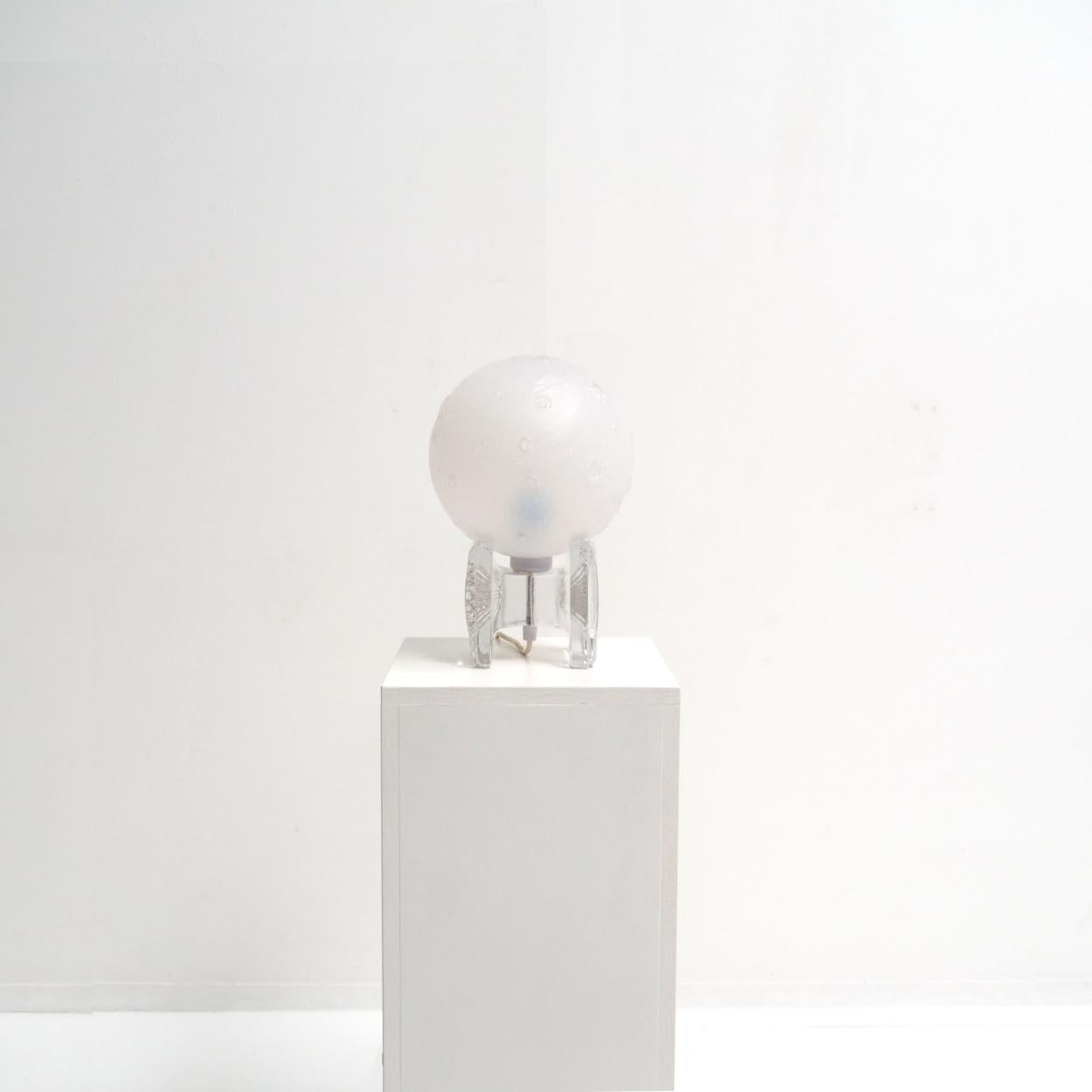 Rare and remarkable lamp designed by Uno Westerberg for Pukeberg Sweden.

The lamp has a frosted glass shade that represents the Earth’s moon. How cool is that? The base is also made of glass. Transparent glass.

The lamp dates from the 1960s and is