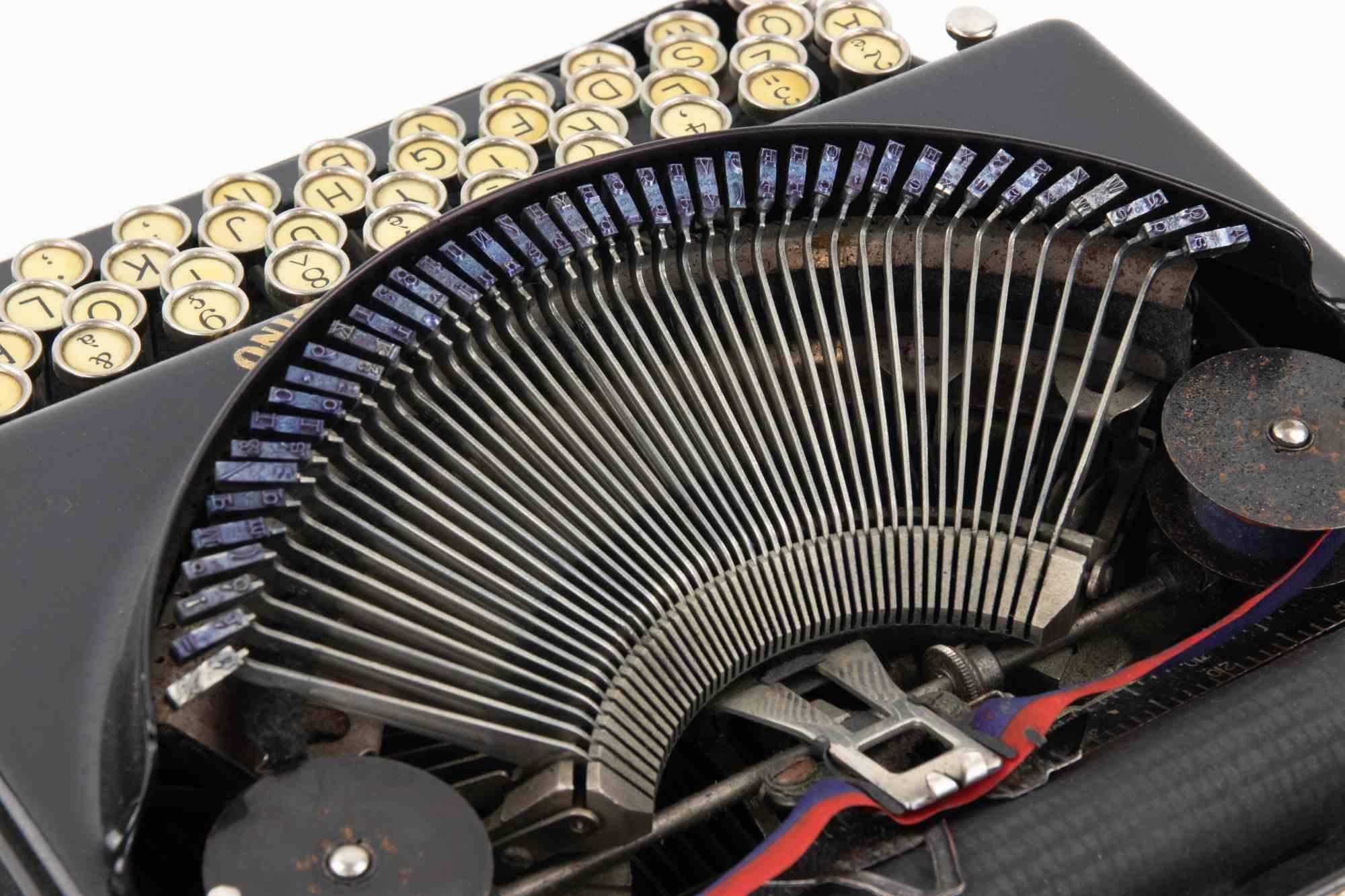 Excelente máquina de escribir portátil Remington de época, fabricada en Estados Unidos y presentada en su estuche original con forro interior verde. El maletín, grabado con el nombre Remington y provisto de un asa de cuero, contiene un compartimento