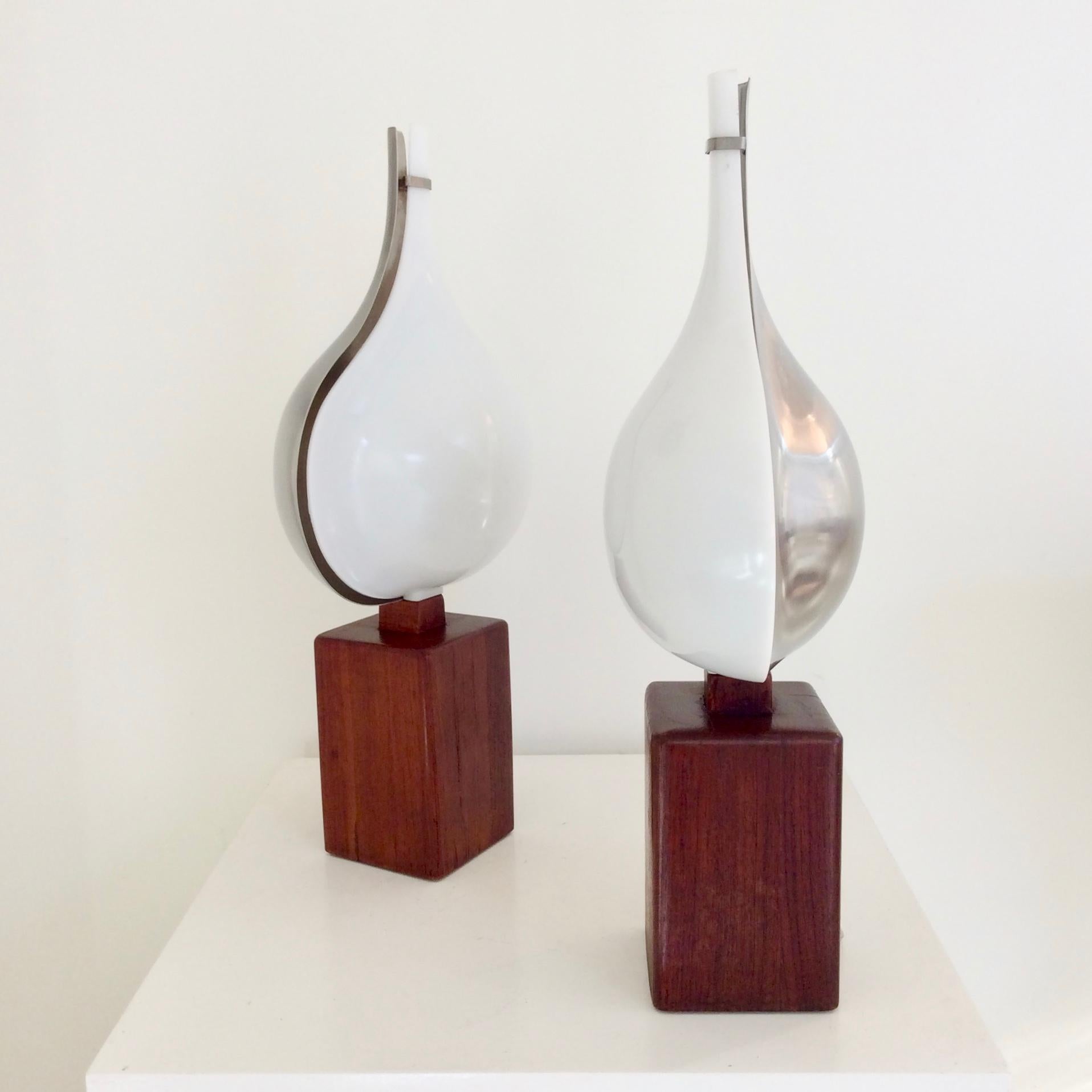 Rare pair of Rémy Letang table lamps, circa 1970, France.
Stainless steel and Perspex reflector, base in solid teak.
One E14 bulb of 40 w.
Dimensions: 47 cm H, 24 cm W, 15 cm D.
Good original condition.
All purchases are covered by our Buyer