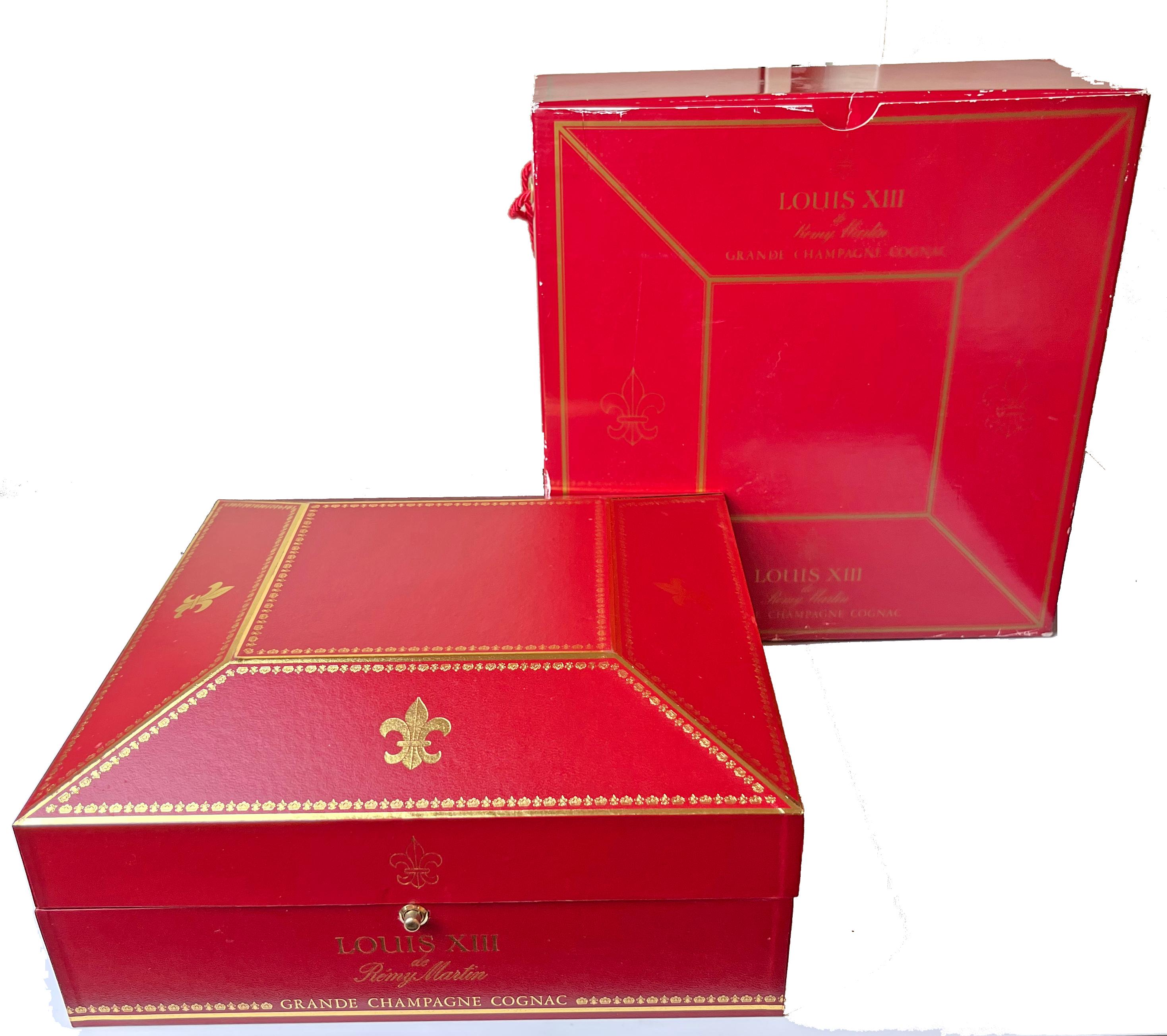 Remy Martin Louis XIII Cognac Baccarat Crystal Bottle in Presentation Box. This is a sealed bottle. Presentation box has minor gold loss, cardboard shelf box has ware.
