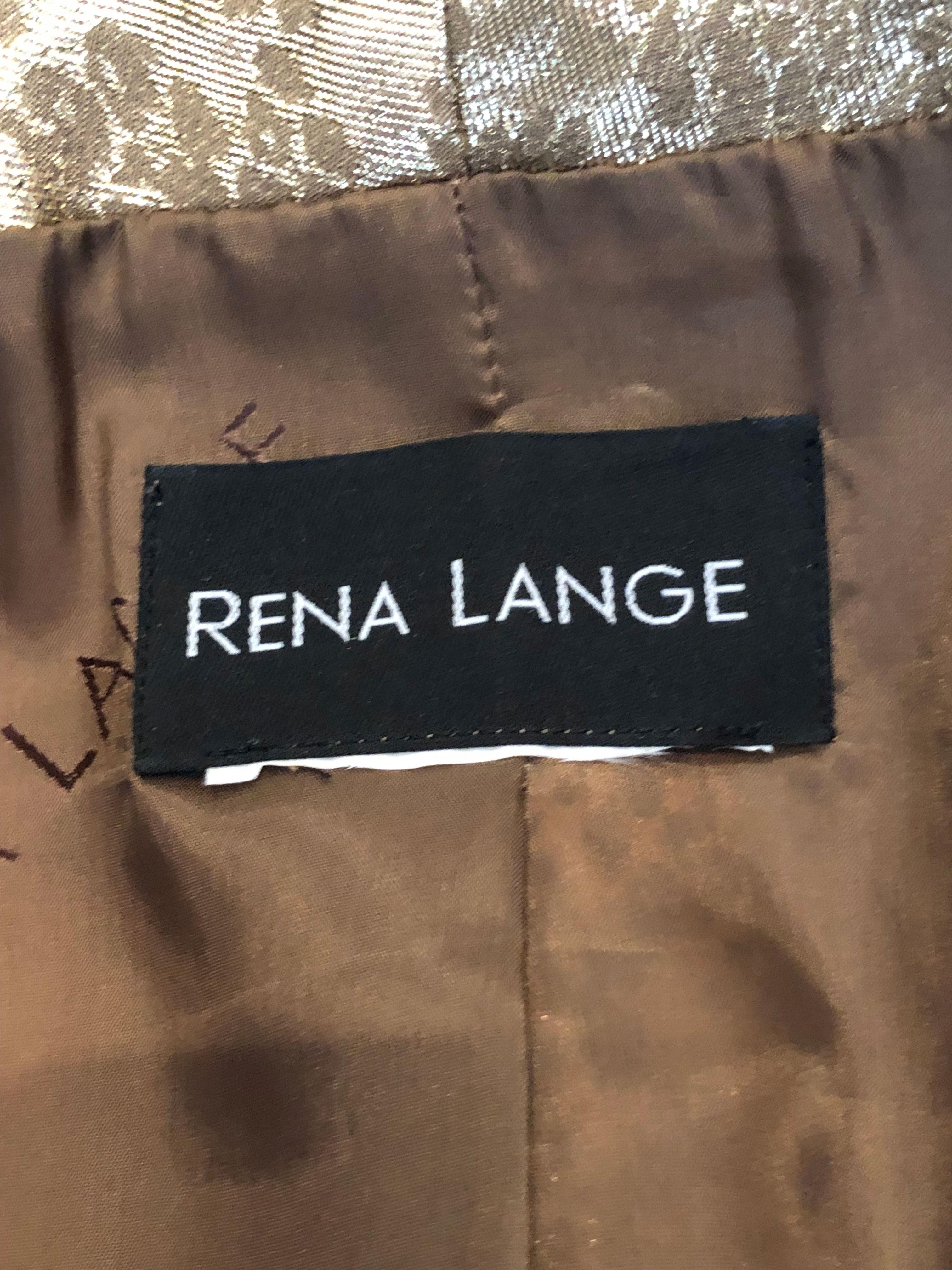 A real statement suit by Rena Lange. The suit jacket is sfari style with four pockets  and the fabric has a snakeskin print detail. Both the trousers and jacket are fully lined. Measurements : Jacket bust 39'', length 30''. Trousers, waist 27'',