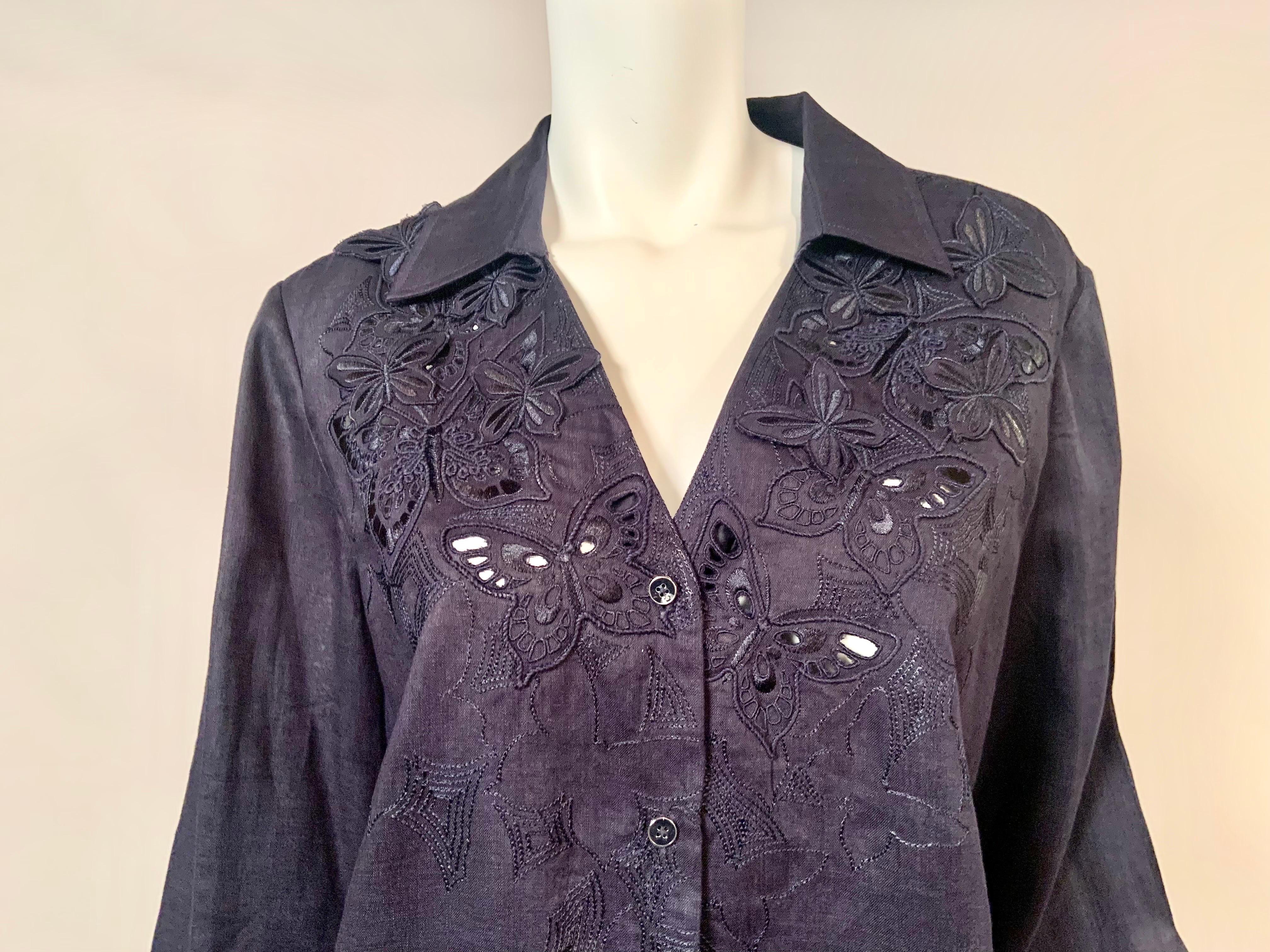 This beautiful blouse from German designer Rena Lange has stunning cut work with floral embroidery and embroidered butterfly appliques. This extends to the third button at the center front.  The shirt has long sleeves with button cuffs, and a yoke
