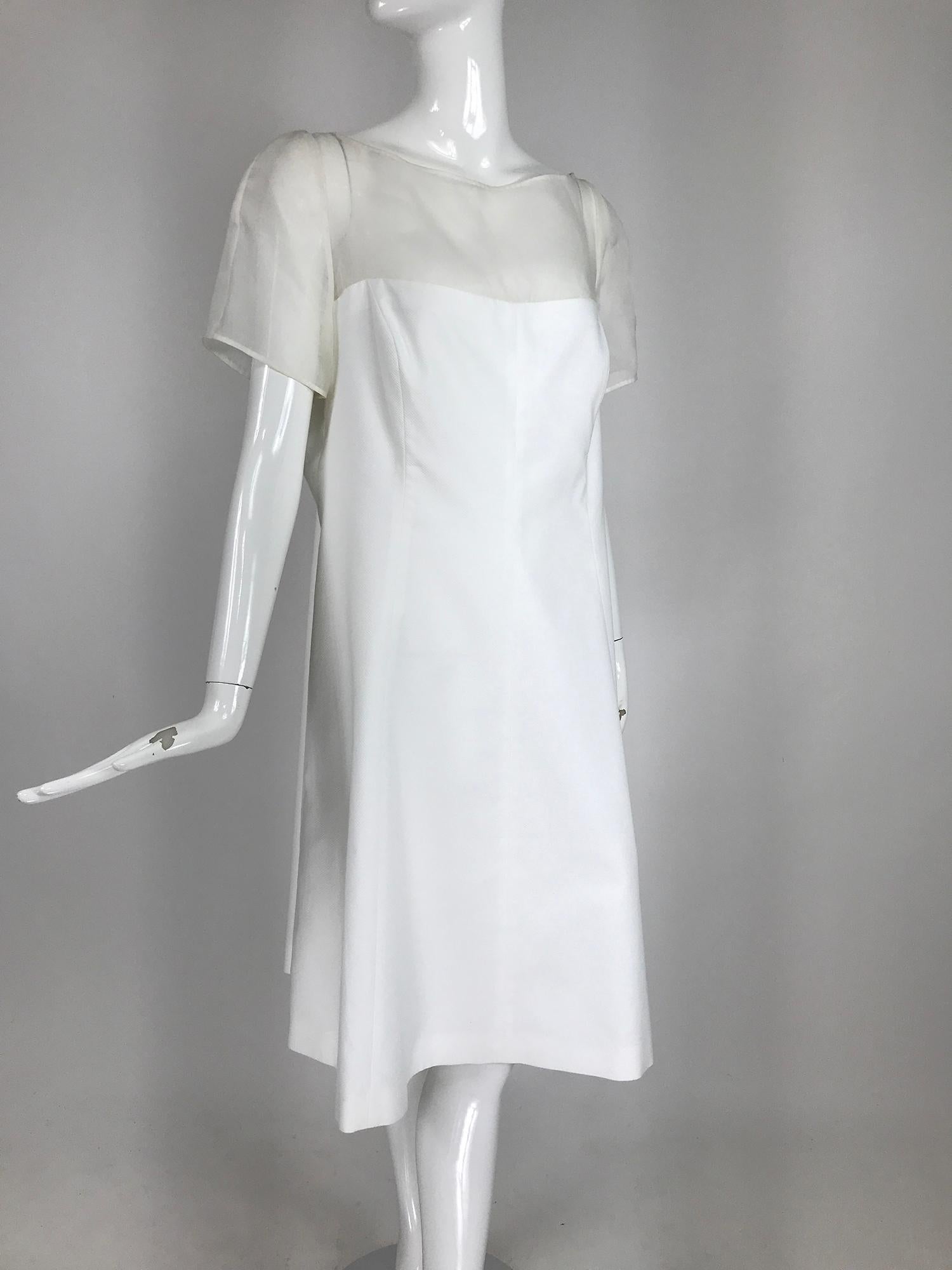 Rena Lange white cotton pique and silk organza day dress, marked US 14. 
Princess seam dress with an upper bodice and sleeves of double silk organza. The dress is crisp cotton pique. Dress closes at the back with a zipper, the organza top is open,