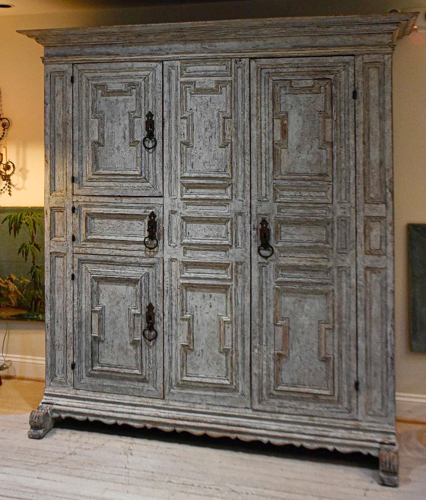 A truly stunning cabinet with a rich patina. Made by a Swedish cabinetmaker in the early 19th century.

The paint on the inside and the outside is all original. Original hardware includes the hinges, locks, key, straps. 

Intricate carved
