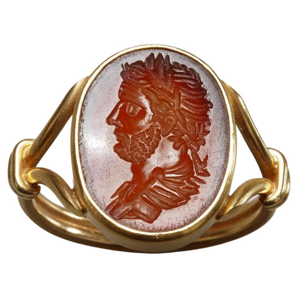 A Renaissance intaglio in carnelian, engraved with a portrait of the emperor Hadrian shown to the left. The ring is with open design ring shoulders and double band shank.
USA 10.5, Europe 23.5.
Weight: 6.58 grams.