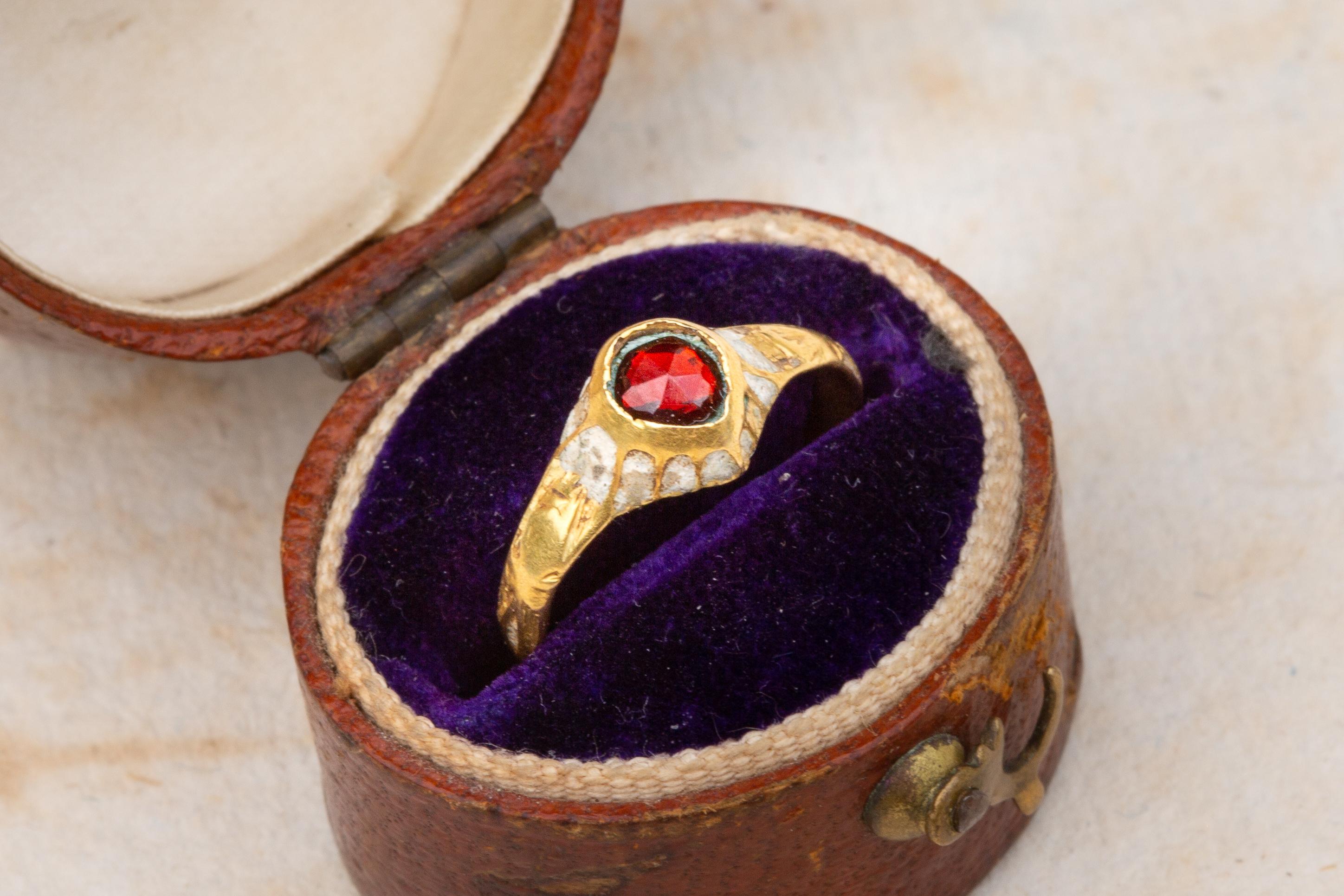 A stunning and rare example of a European renaissance ring dating to circa 1600! It would have originally been worn by a young women of a wealthy and noble family. The tear-drop shaped bezel is encircled by multiple cuffs enamelled in white.