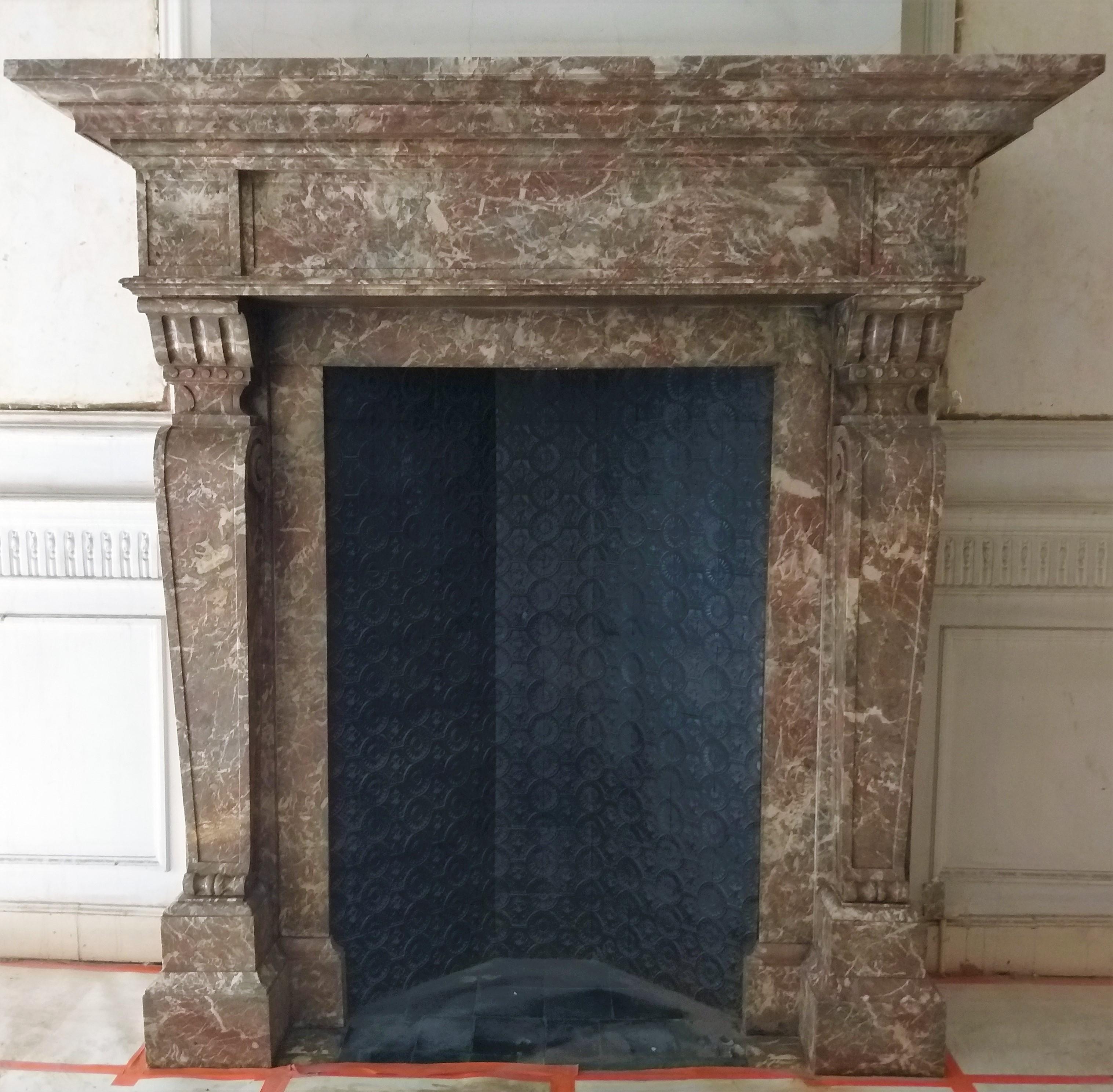 A large and imposing Renaissance fireplace from Belgium-Brussels. Made out of the highly valued, soft-toned Saint Rémy marble.
The stepped, two meters large shelf is resting on a simple panelled frieze. The voluted, bold and tapered pilasters are
