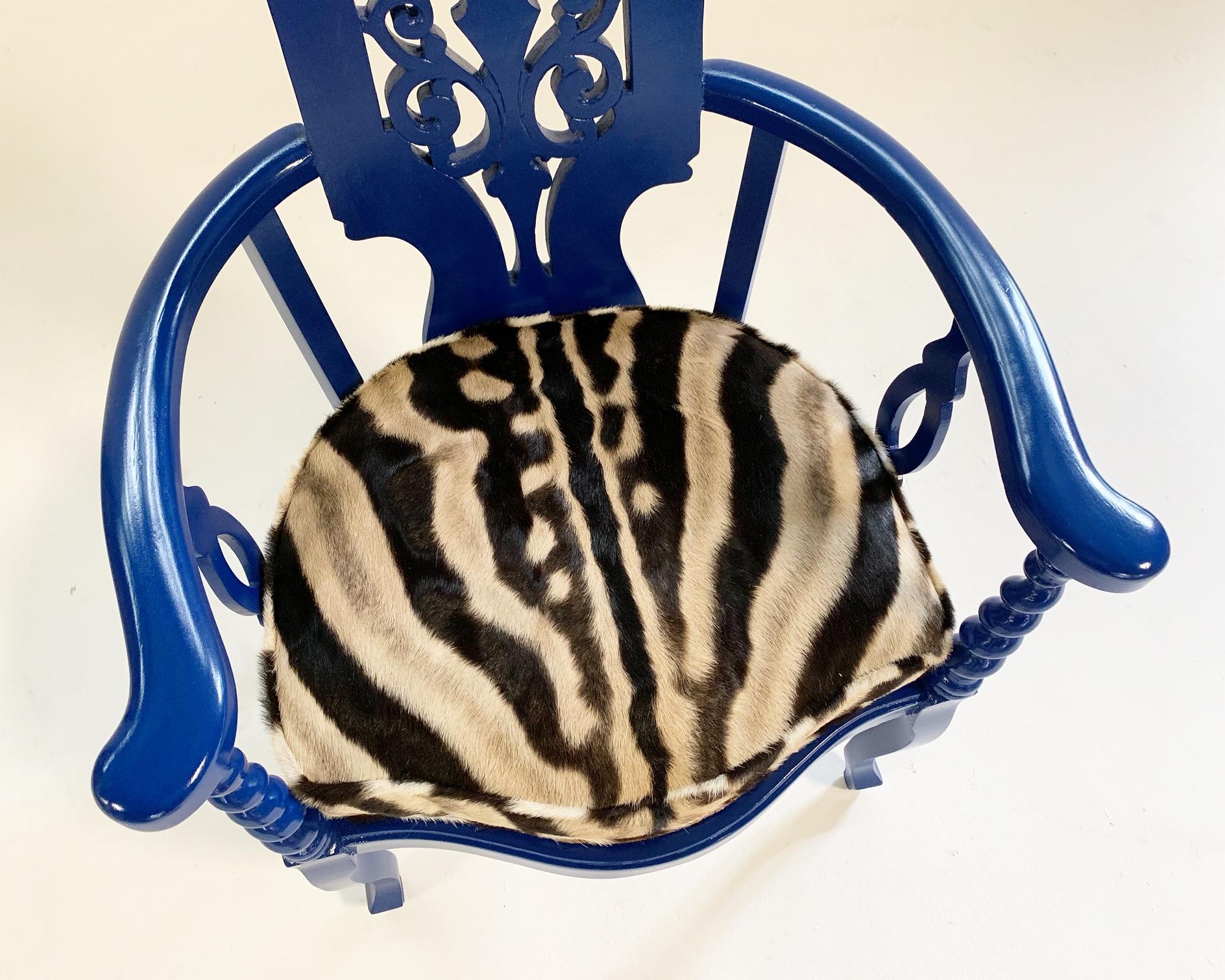 We love this elegant Renaissance revival armchair. The oak needed some TLC so we decided to make it loud and paint it a cool Yves Klein blue. The seat is caned and we added a custom zebra hide cushion for pop. Feather filled of course!