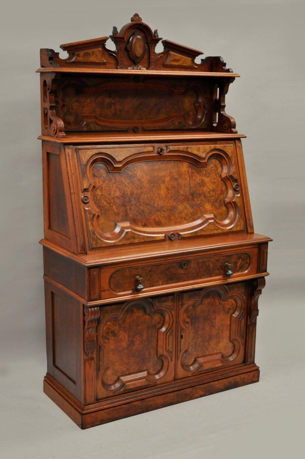 Antique Victorian/Renaissance Revival burl walnut drop front secretary desk. (Be sure to check item measurements as some items appear larger in photographs than in person). Item features solid two-piece wood construction, finely carved details,