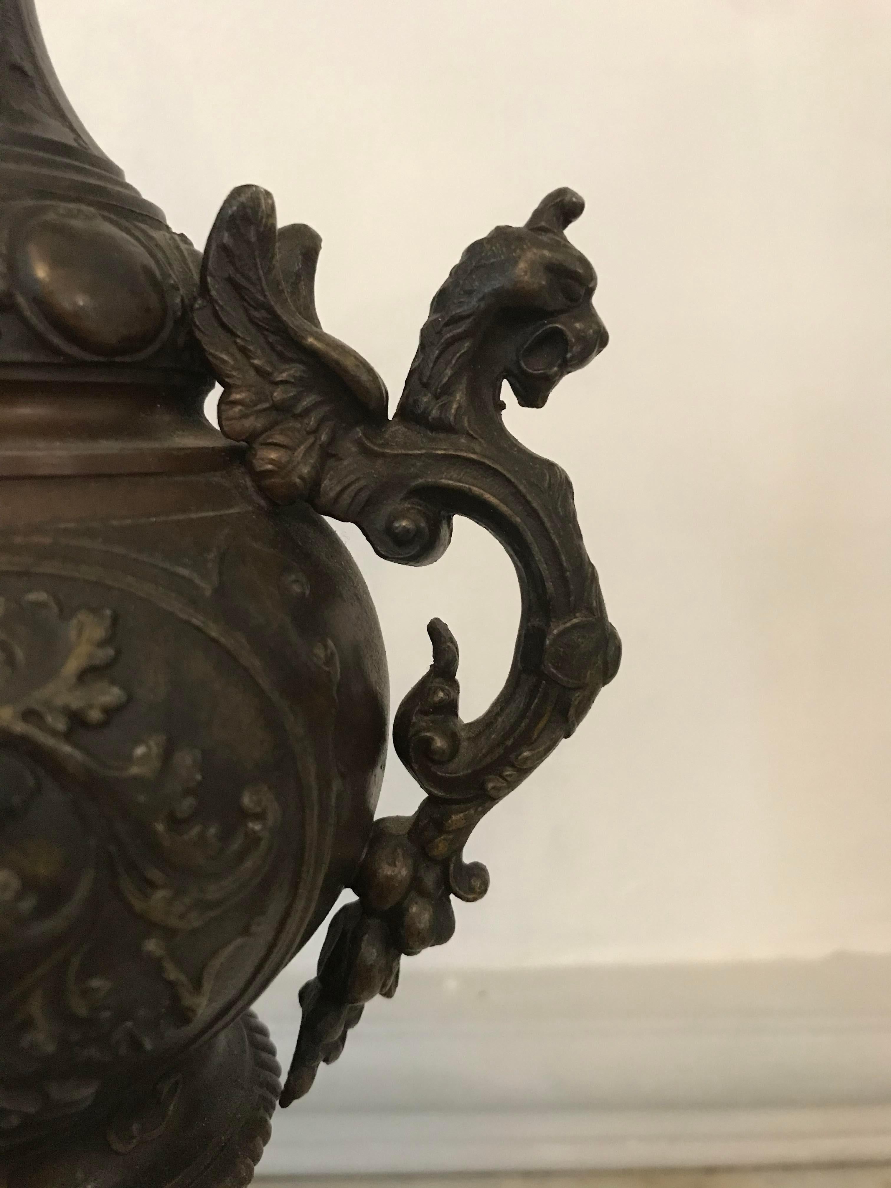 A large neo-renaissance ewer in bronze with dragon decoration. The foot has a gadroon motif and rests on a marble terrace.