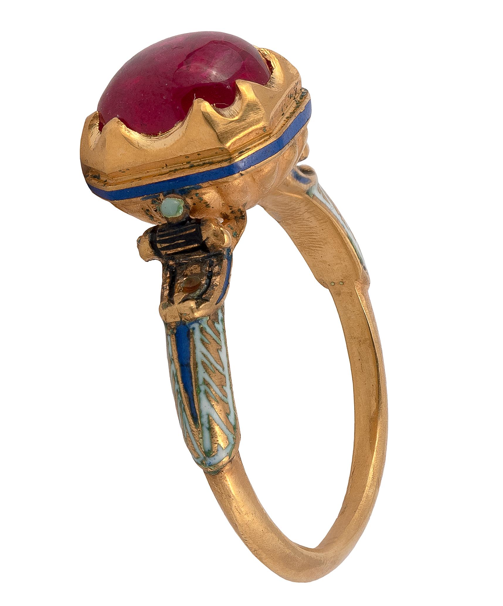 The cabochon ruby, in an elaborate neo-Renaissance gold mount, decorated in enamel diverse motifs, 
ring size O-P, 
length 13mm, 
width 9mm