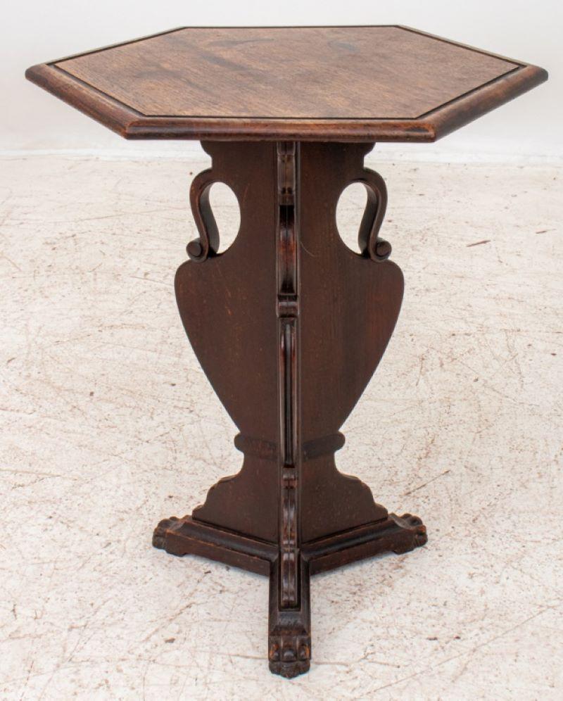 Renaissance Revival hexagonal mahogany table, in the Northern Italian style, the base of tripartite urn form supporting a hexagonal top. 26