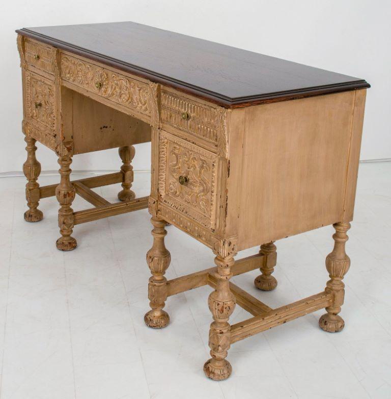 Renaissance Revival kneehole desk, with rectangular walnut top above a white painted two pedestal desk, with one long and two short drawers above two cabinets, all decorated with renaissance motifs, each pedestal on eight legs conjoined by H-form