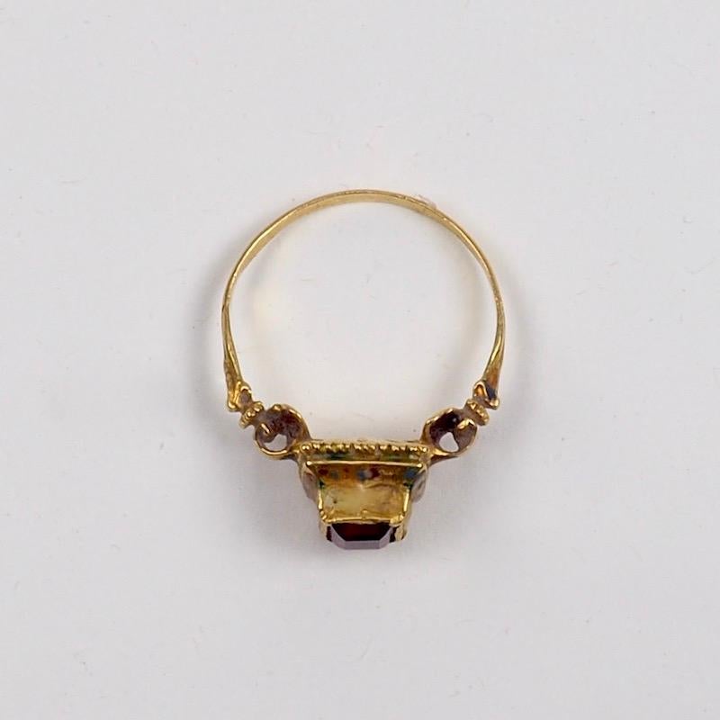 Renaissance Revival Gold, Garnet and Enamel Ring. 
Fashionable throughout Europe in the Pre-Raphaelite period of the 19th Century, rings like this were made in the Staatliche Zeichenakademie in Hanau, Germany, based on original Renaissance examples.