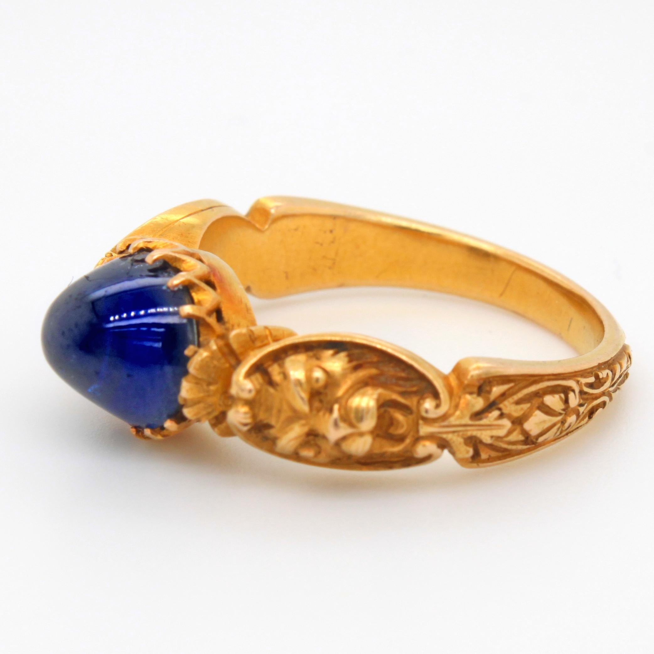 An antique Neo-Renaissance sapphire and gold ring. ca. 1840s. The sapphire cabochon weighs approximately 3.7 carats, is natural (not heat treated) and has a deep royal blue colour. It has some abrasions/feathers and the inclusions show signs of