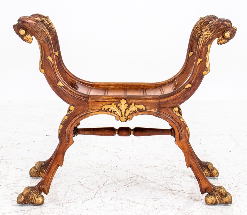 Renaissance Revival style parcel-gilded carved wooden bench, with lions' head terminals and acanthus carved supports joined by turned stretchers, the x-frames above hairy paw feet. Measures: 24