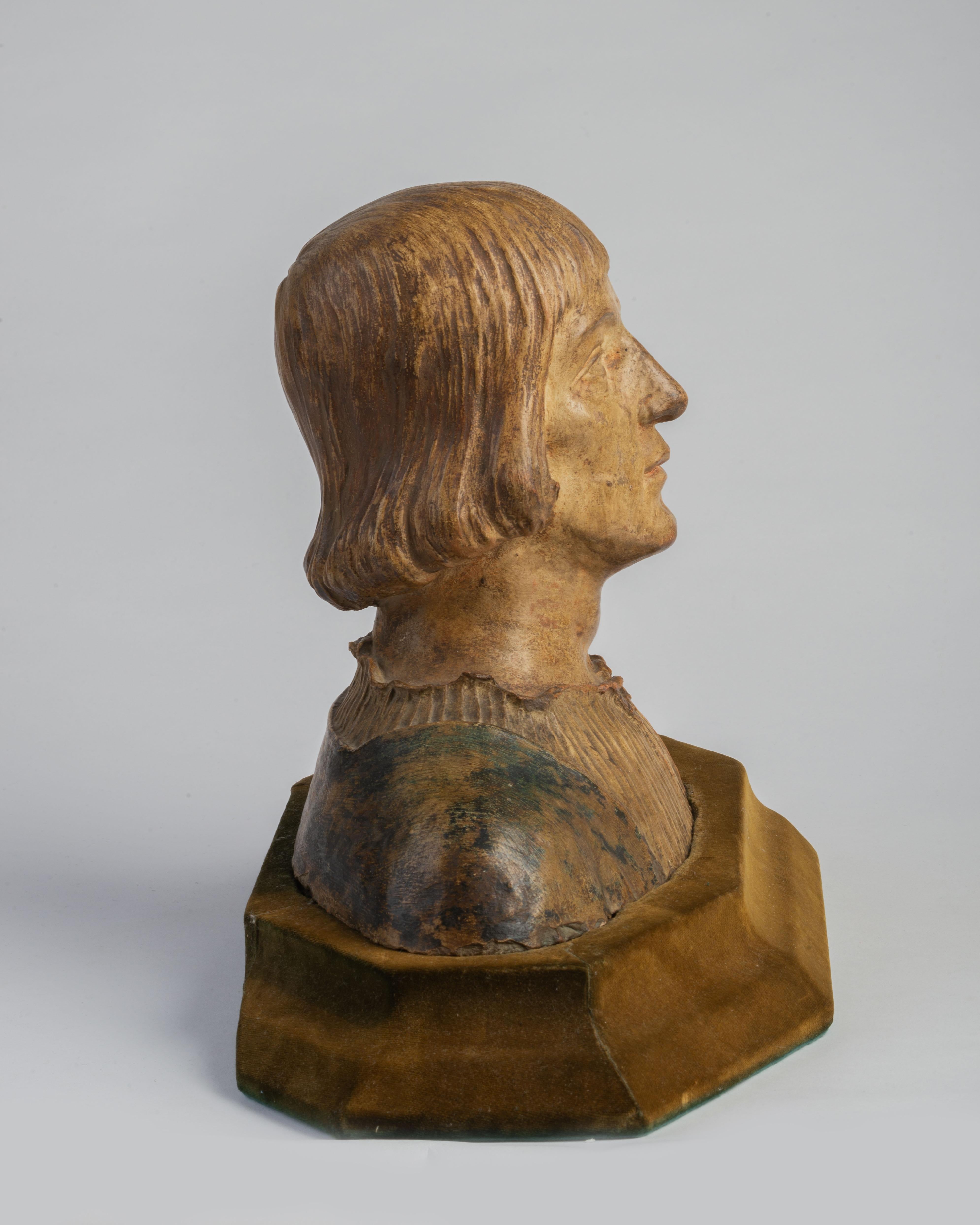 Raised on an olive velvet base. Dimensions include the base.
Portraiture is often seen as the quintessential Renaissance art form, and clay was used increasingly during the 15th century to produce life-like busts. It was an ideal medium to make