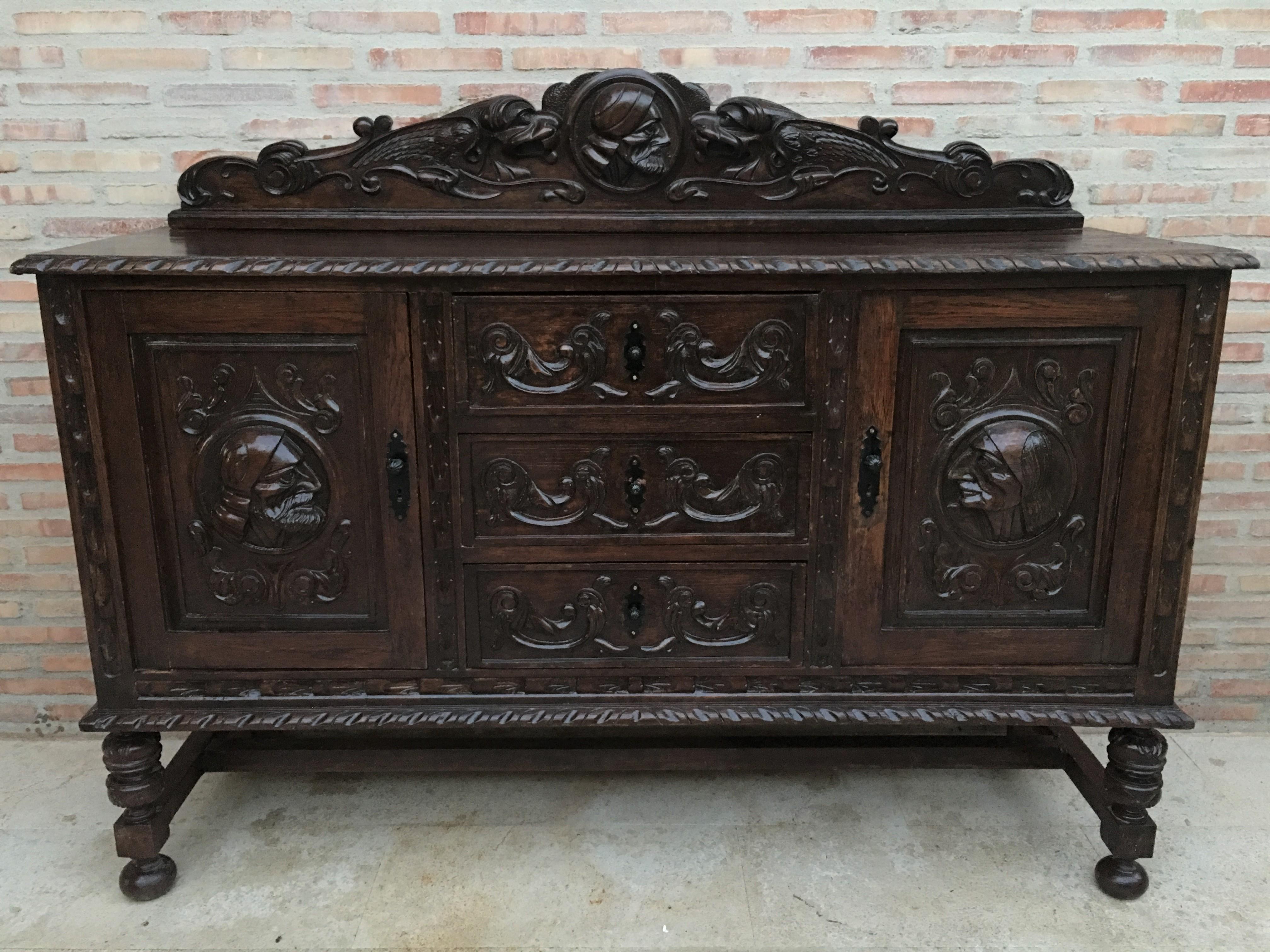 19th century Spanish Renaissance buffet was sculpted from dense, old-growth oak with glorious full relief depictions. Set upon a brilliantly molded framework, the carved door panels are framed by clockwise and counter-clockwise barley columns, with