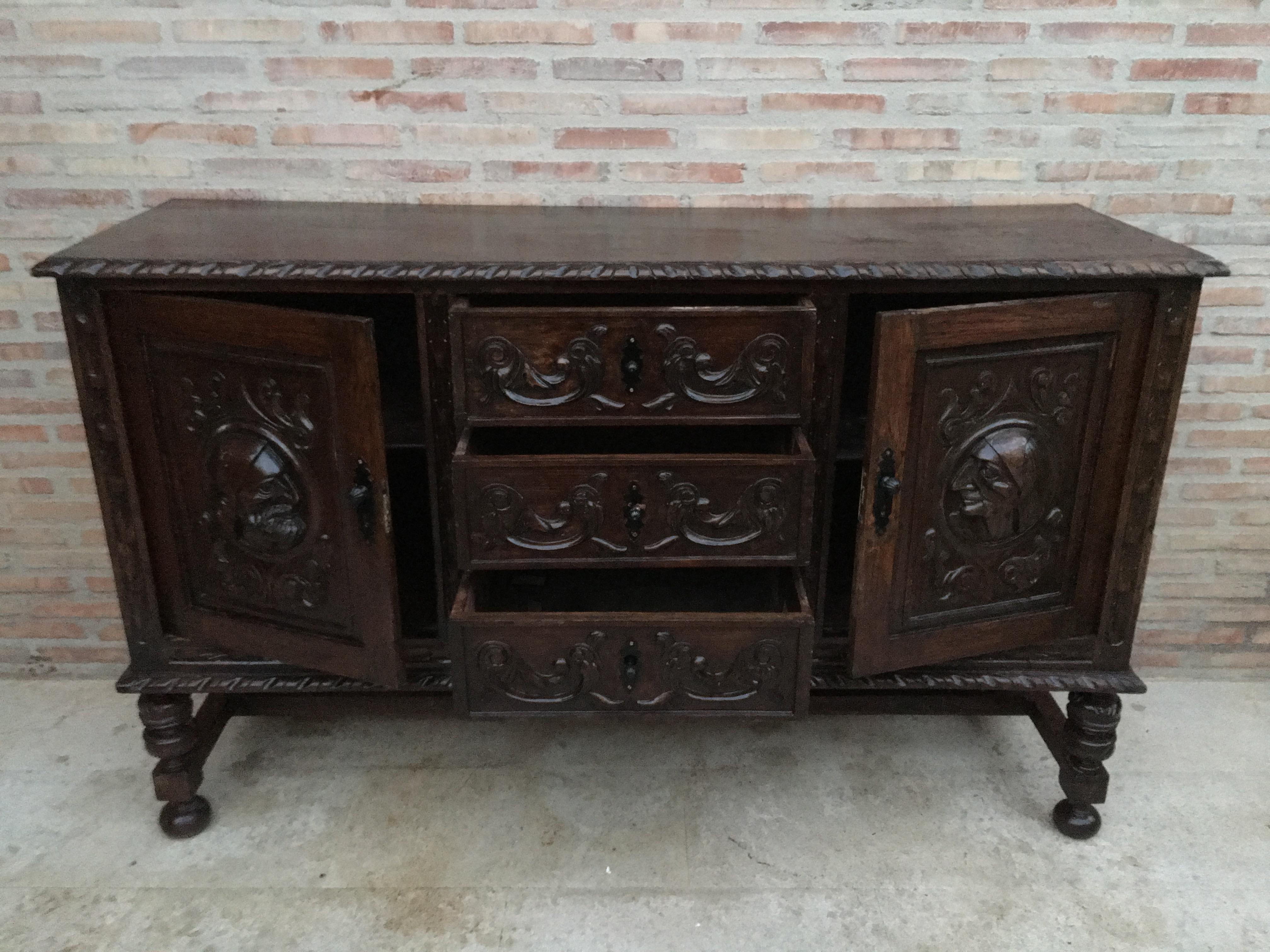 19th century Spanish Renaissance buffet was sculpted from dense, old-growth oak with glorious full relief depictions. Set upon a brilliantly molded framework, the carved door panels are framed by clockwise and counter-clockwise barley columns, with