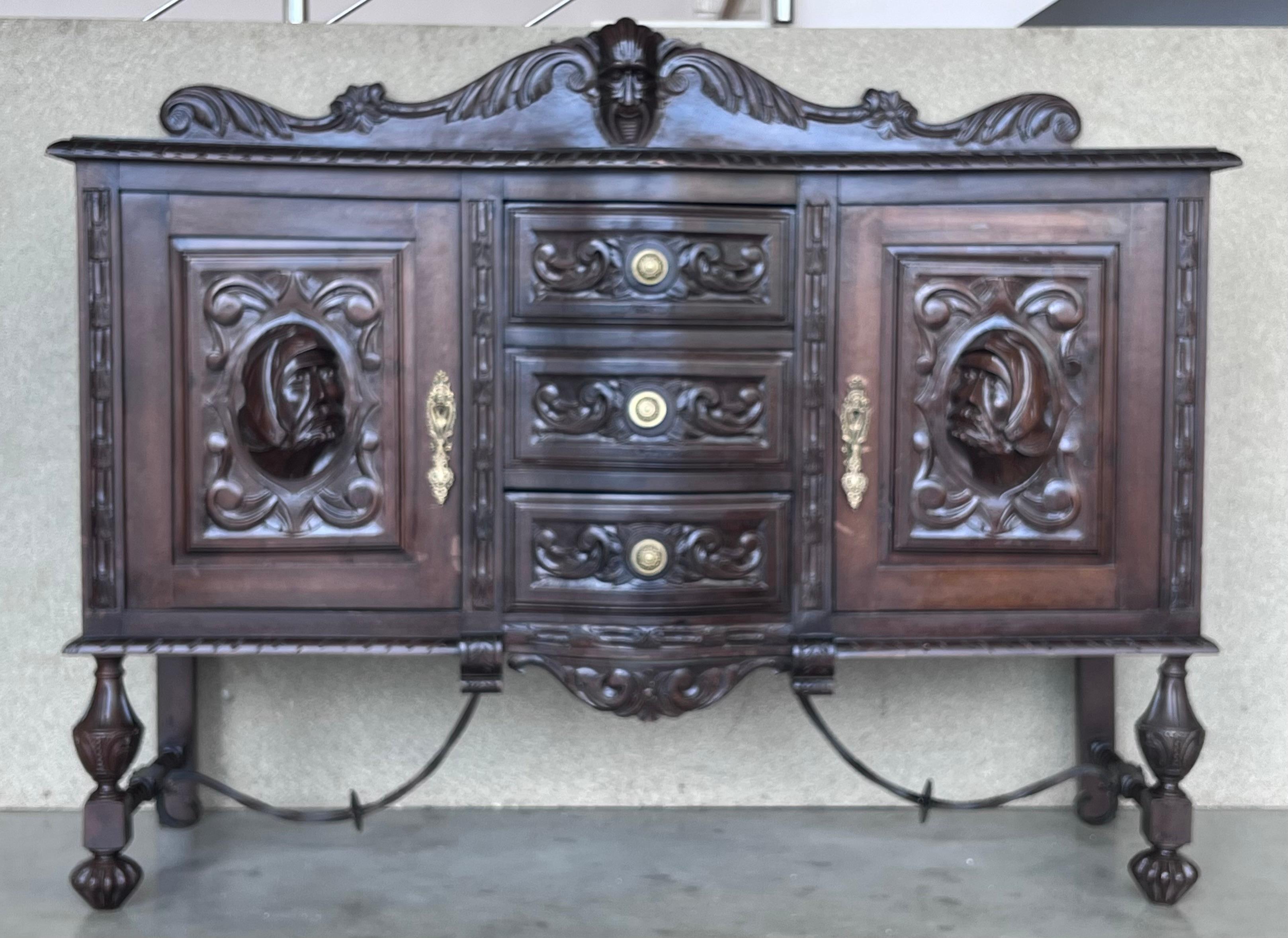19th century Spanish Renaissance buffet was sculpted from dense, old-growth oak with glorious full relief depictions. Set upon a brilliantly molded framework, the carved door panels are framed by clockwise and counter-clockwise barley columns, with