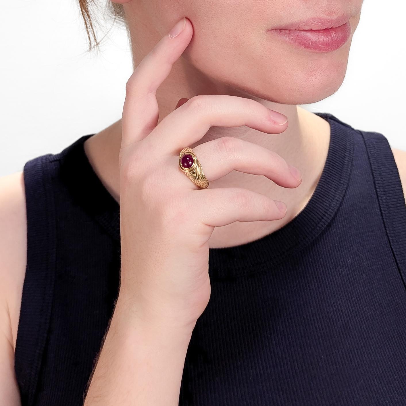 A fine gold & ruby ring. 

In 18 karat yellow gold.

With a bezel-set opaque ruby cabochon, engraved decoration to the shoulders, and a tapered shank.

Marked to the shank.

Simply a wonderful Renaissance style ring!

Date:
20th Century

Overall