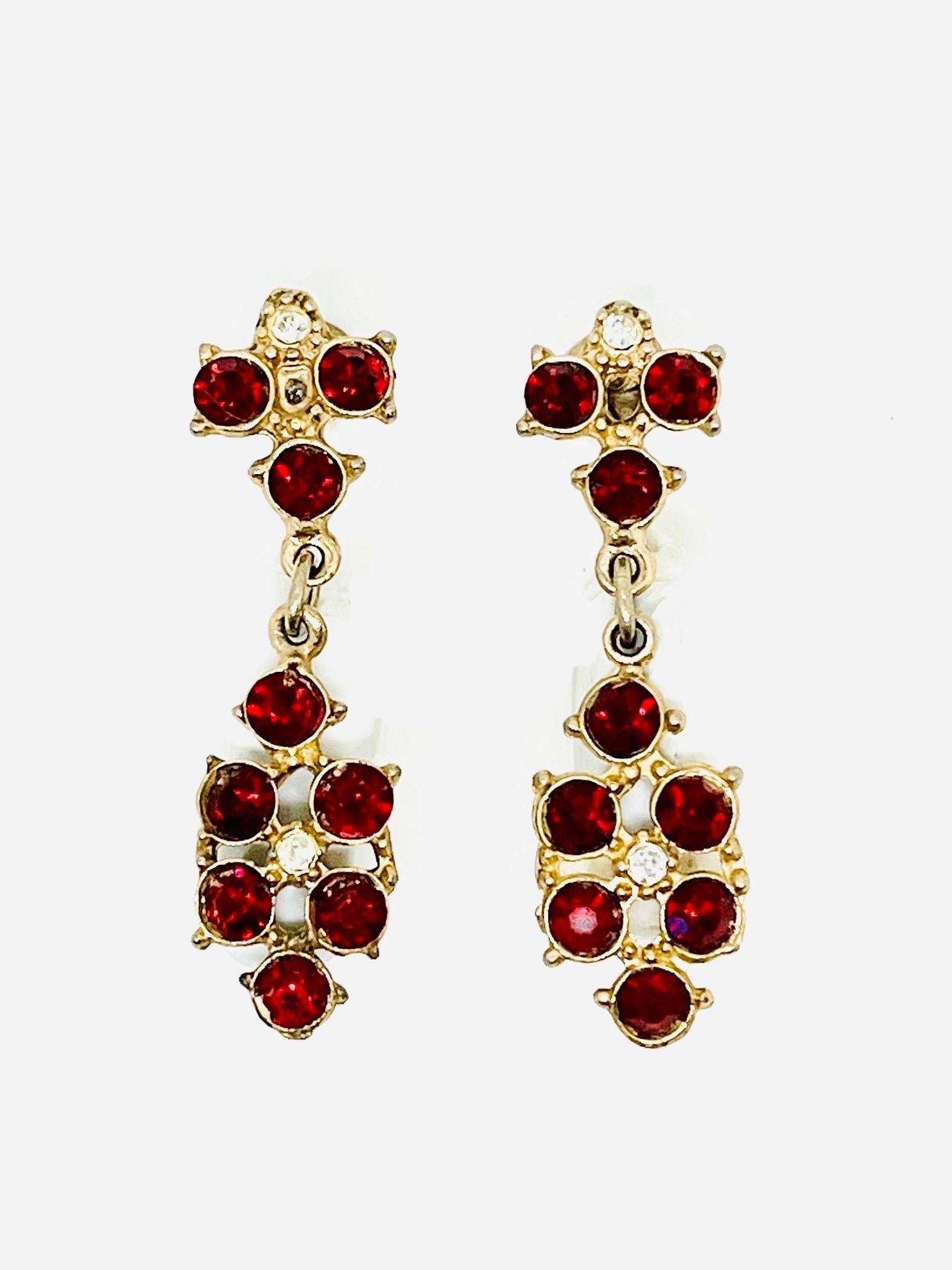 Antique Renaissance Style dark red and clear glass Rhinestone Screwback Dangle Earrings, 1910s. Goldtone brass has a finish that is in between satin and polished. Beautiful gridded metal detail visible on back. Nine round cut garnet-colored and two