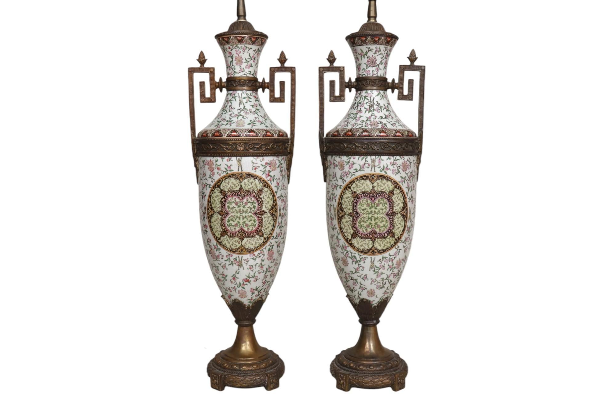 Ein Paar Urnen-Tischlampen im Renaissance-Stil aus patinierter Bronze und Porzellan. Jede Urne ist handbemalt mit einem rosafarbenen Blumenrankenmotiv mit springenden Fröschen und erhabenen emaillierten Rändern um ein zentrales Medaillon, das mit