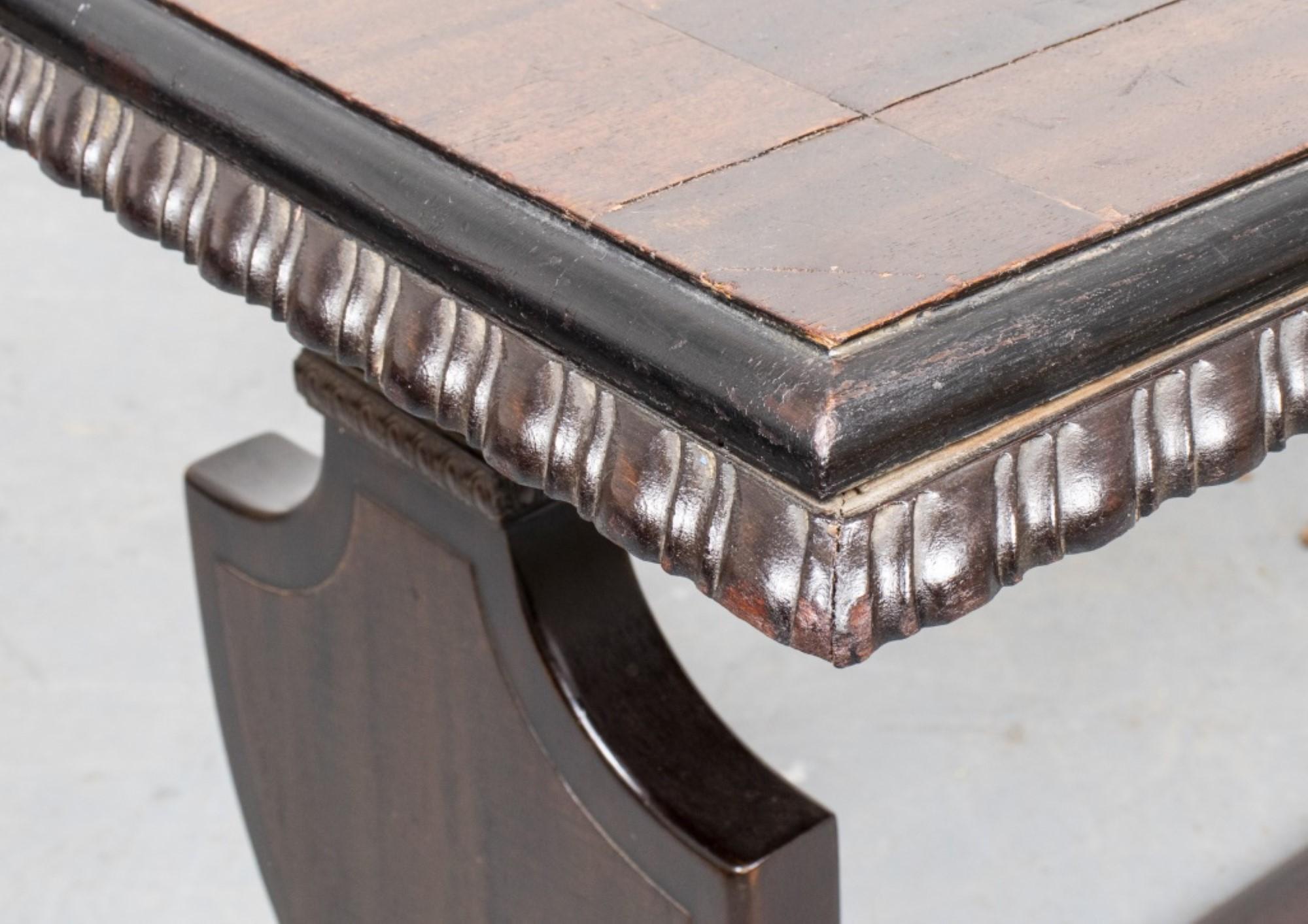 Renaissance style oak library table or desk, the top with carved details over the shield-form legs.

Dealer: S138XX