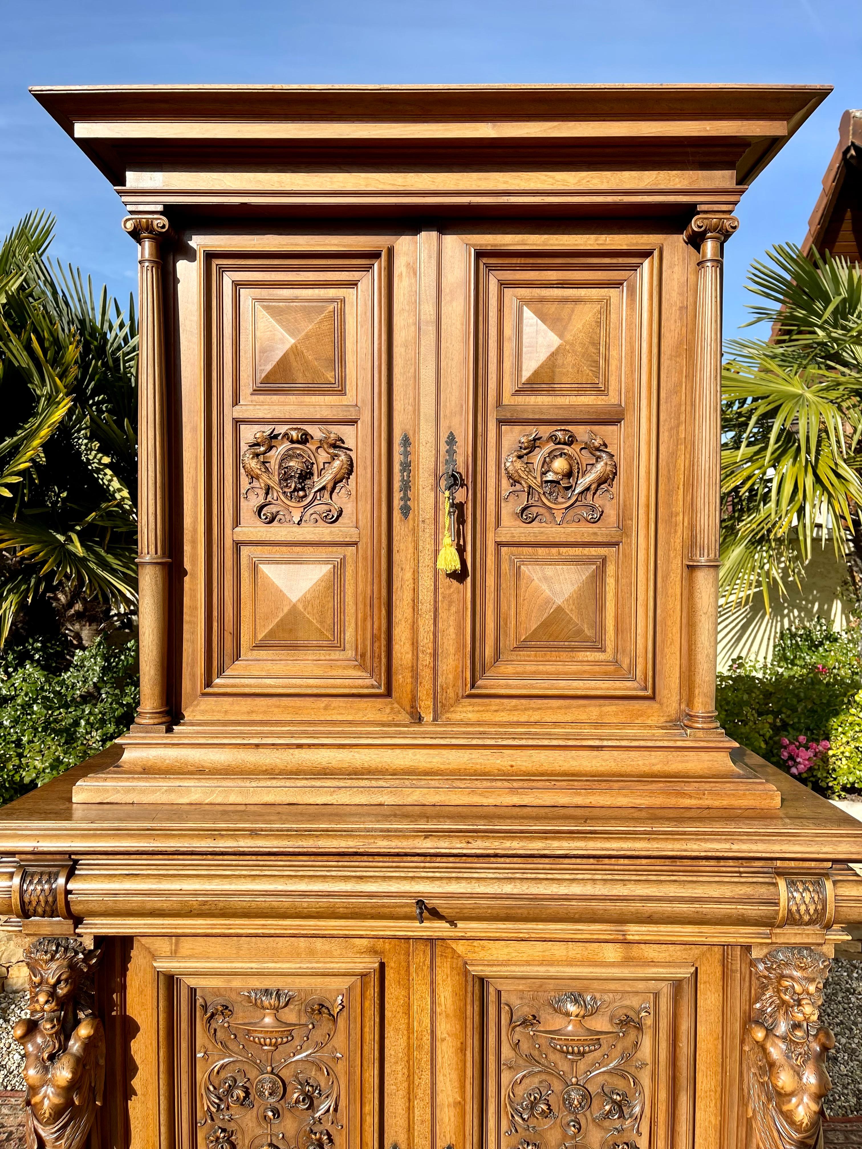 Renaissance style walnut sideboard finely carved with chimeras. This sideboard opens with 4 doors and a drawer. This piece of furniture is complete (shelves and keys) and in good condition.