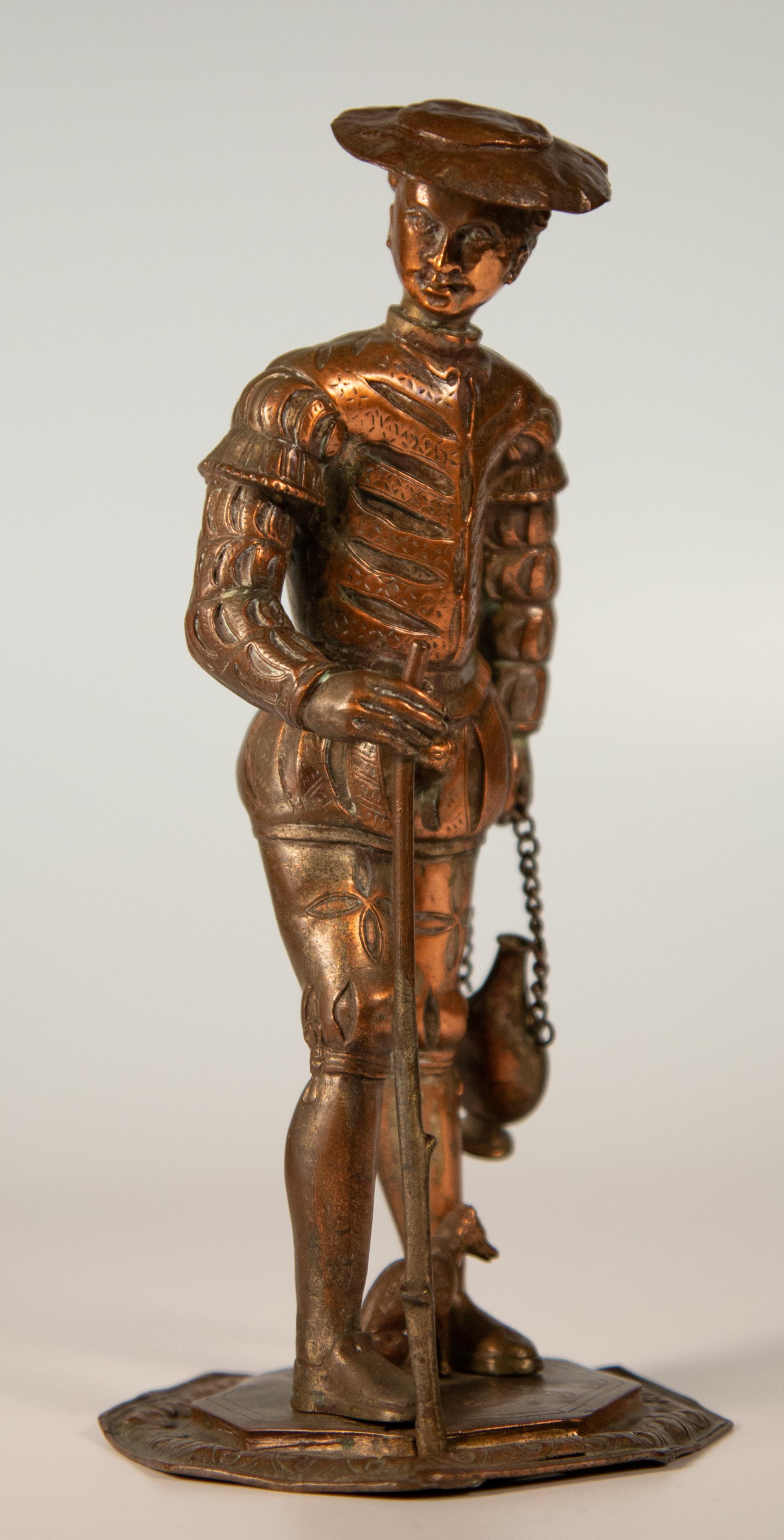 Renaissance style figure of a pilgrim with a small dog. Continental hammered, repouusse and incised copper, circa 1860.