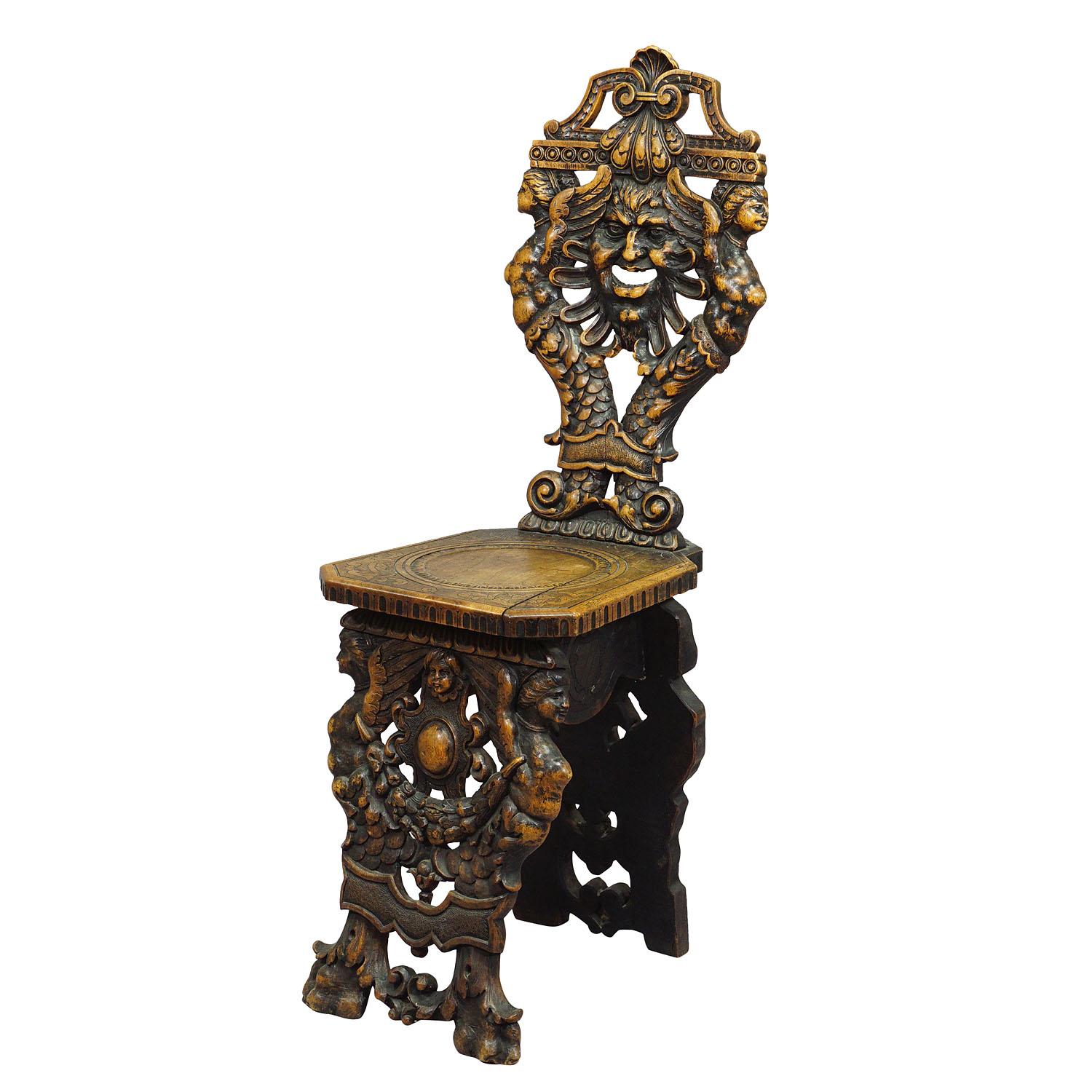A wonderful handcarved oak wood sgabello board chair - backrest and feet carved in Renaissance style with fantastic grimace, gargoyle and floral carvings, Italy ca. 1860.

Measures: width: 13.39