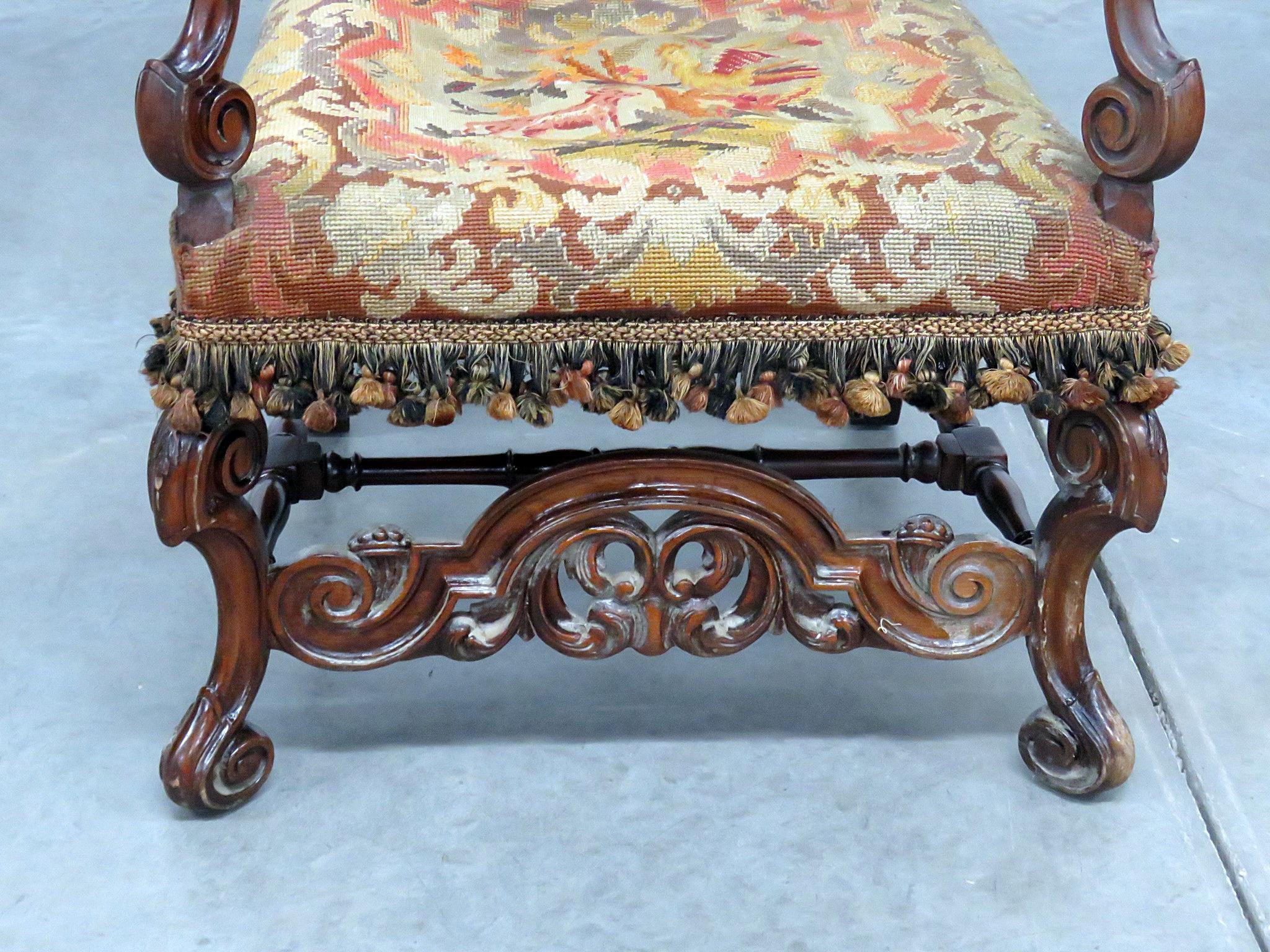 Renaissance style throne chair with needlepoint upholstery.