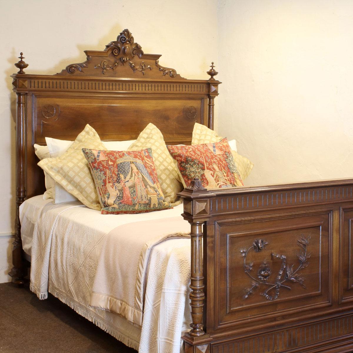 A Renaissance style walnut bedstead with stunning decorative panels and turned posts. 

This bed accepts a British king size or American queen size, 5ft wide (60 inches or 150cm) base and mattress set.

The price includes a firm bed base to