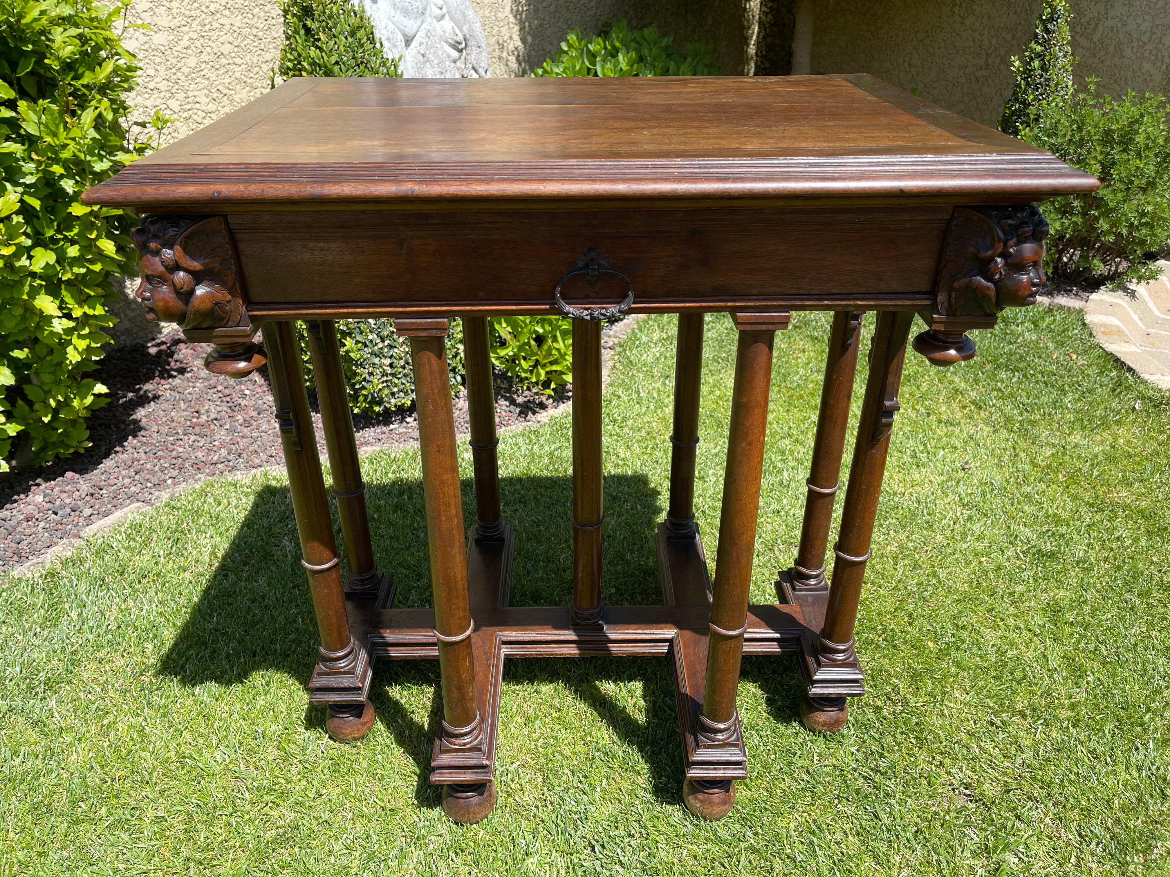 Small living room table or side table in carved walnut Renaissance style. It rests on 9 feet and has a drawer. French work of the nineteenth century of good quality. Good condition.