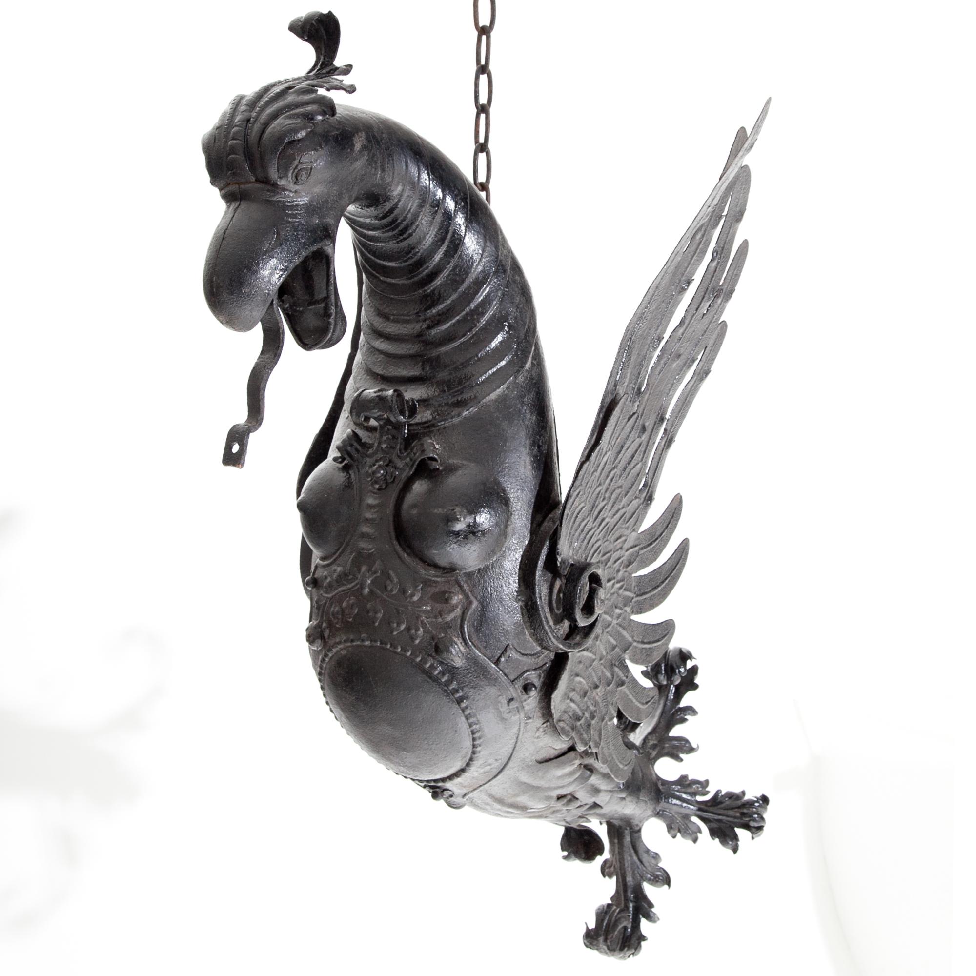 Large Renaissance-style water gargoyle in the shape of a winged dragon out of wrought iron. 
The length with chain is 160 cm.