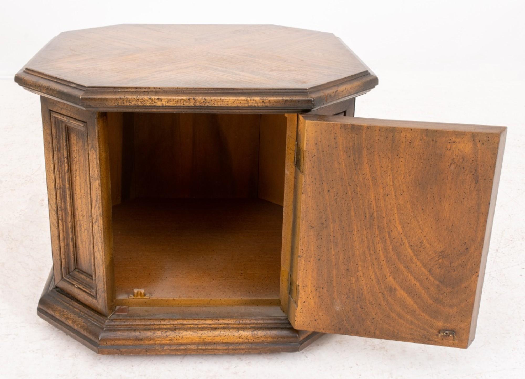 Octagonal side table in the Renaissance taste, featuring doors with low relief carving, and mounted on a molded plinth. The dimensions are approximately 21 inches in height, 26 inches in width, and 26 inches in depth.