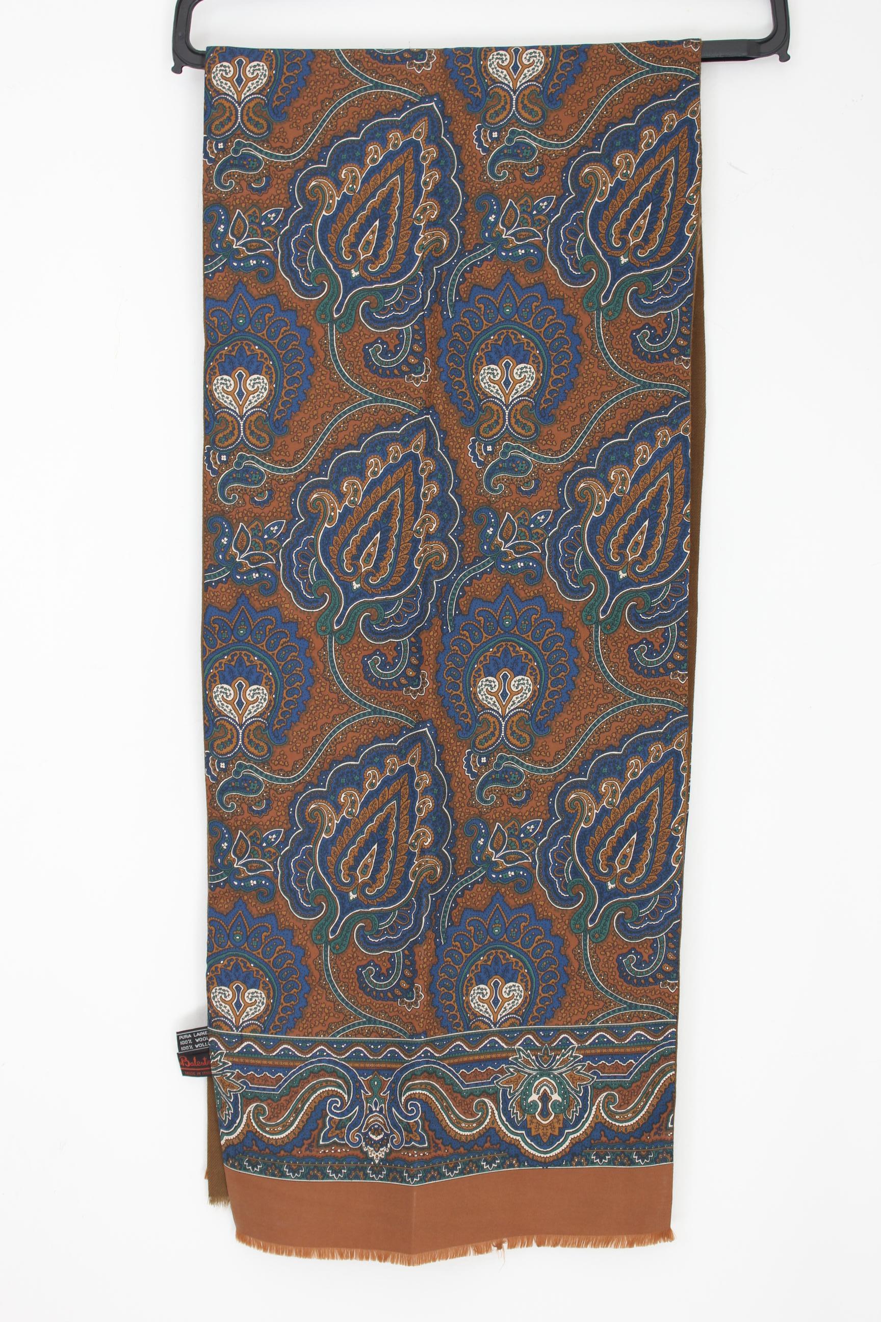 ntroducing the Renato Balestra tubular scarf, a stunning piece that will elevate any outfit. This vintage scarf, dating back to the 90s, features a gorgeous brown hue with a striking paisley pattern in shades of blue, green, and beige. The scarf is