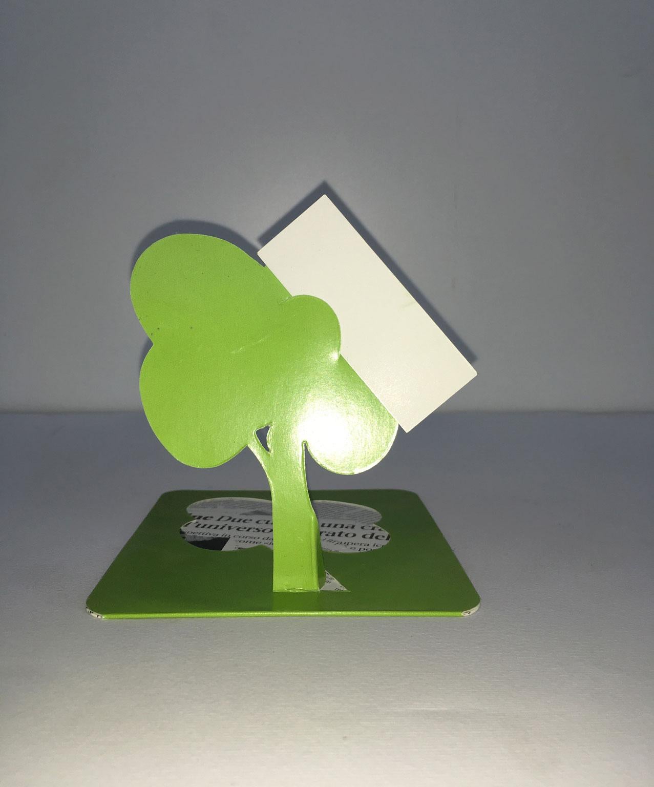 This little and nice sculpture is a cardholder. Cardboard and newspaper print are the materials.
The recycled paper of the newspaper represents one of the first times when the word 