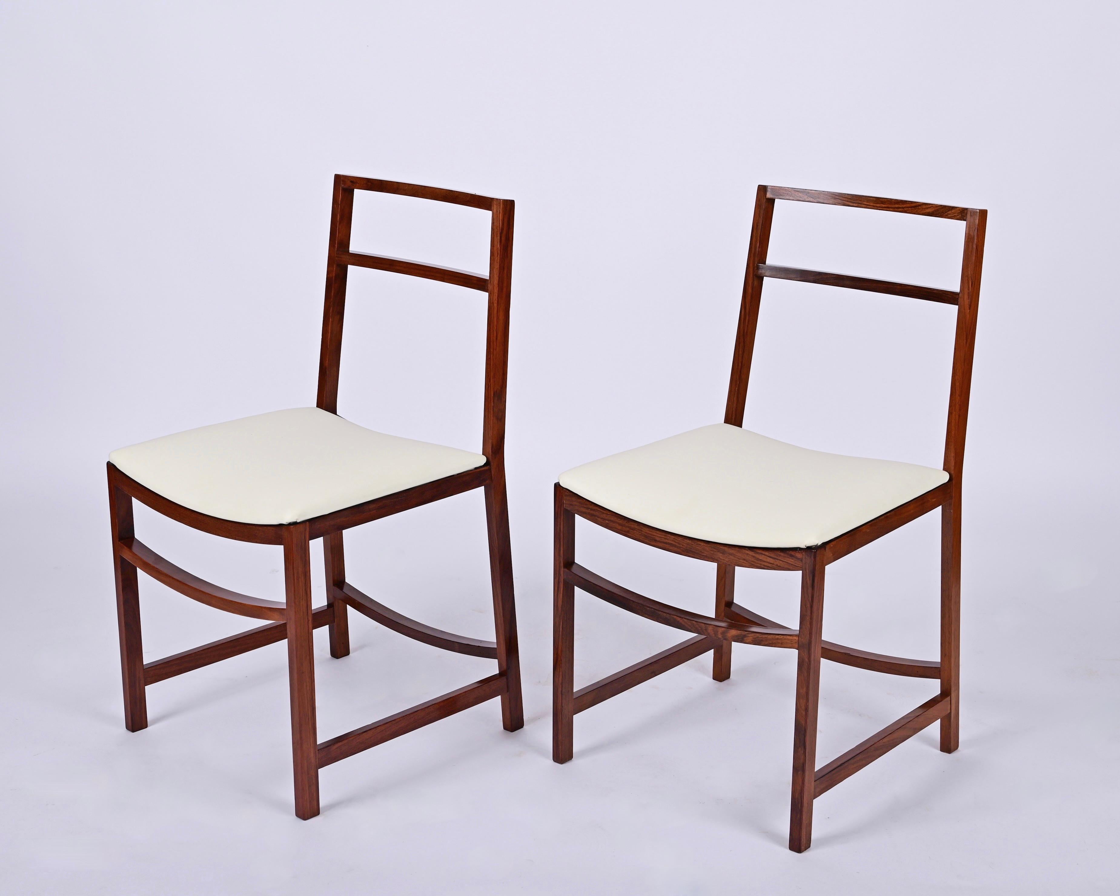 Magnifique ensemble de 8 chaises du milieu du siècle conçues par Renato Venturi pour MIM Roma dans les années 1960 en Italie.

Ces chaises emblématiques sont dotées d'une structure en bois massif et d'assises en similicuir couleur ivoire