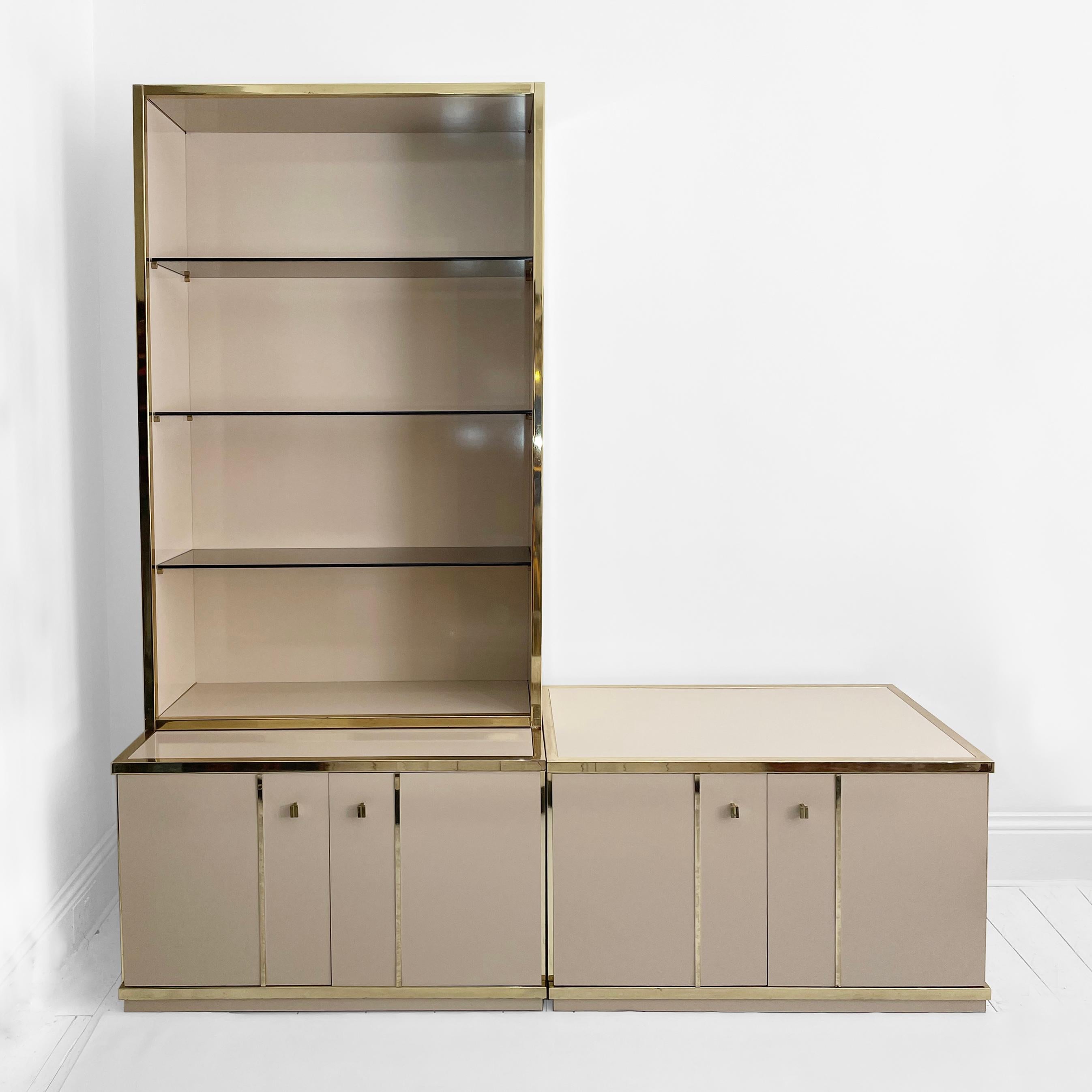 This muted beige and brass sideboard and display cabinet combo, designed by 70s powerhouse Renato Zevi, is a fine example of the marriage of function and elegance that defined the era. Two low and wide cream veneered wood bases support a four-tiered