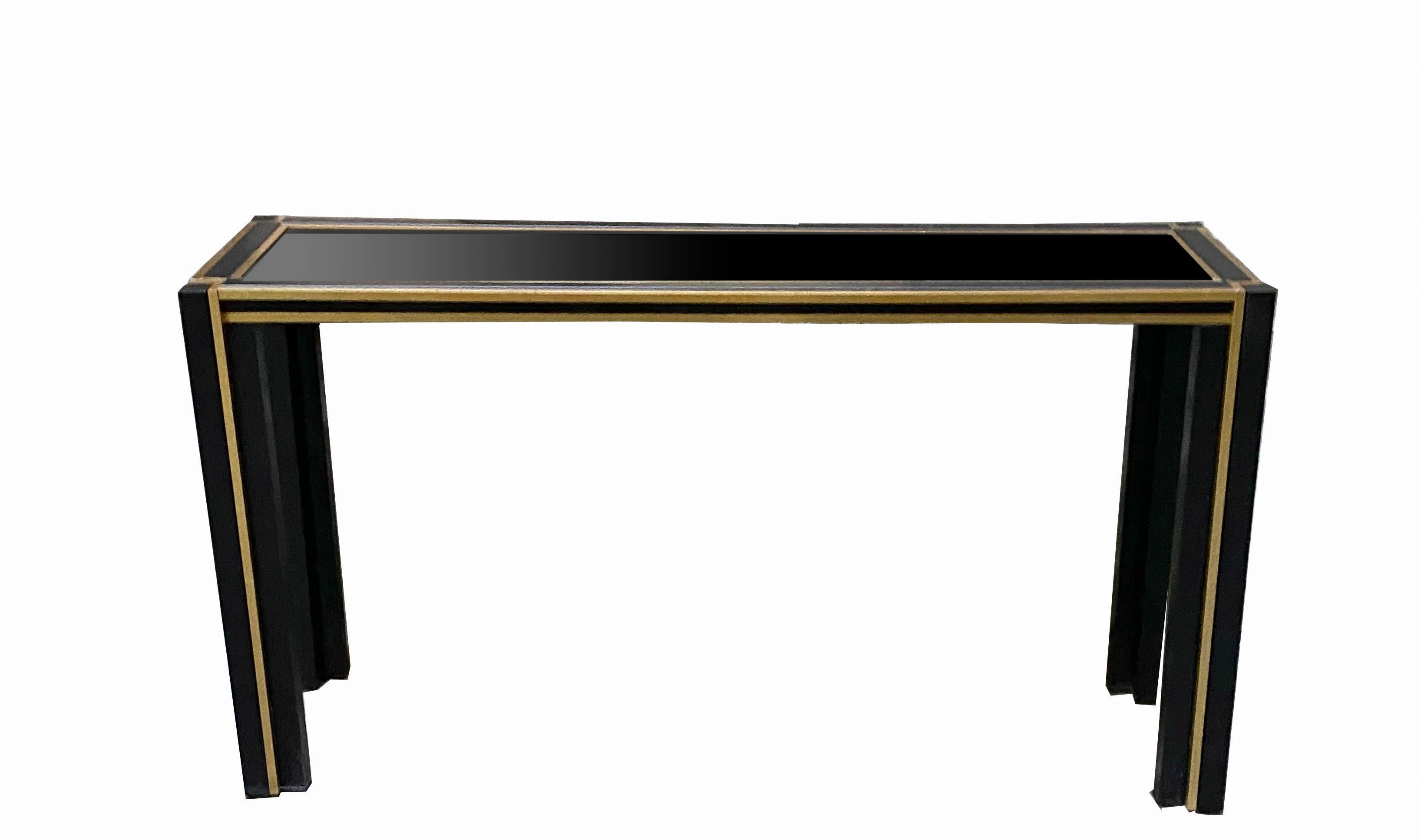 A fantastic and rare Italian console table by Renato Zevi, it was produced in Italy in the 1970s.
It is made from black aluminium and brass finish, has a recessed glass top and is finished on all sides. 
The condition is excellent throughout, with